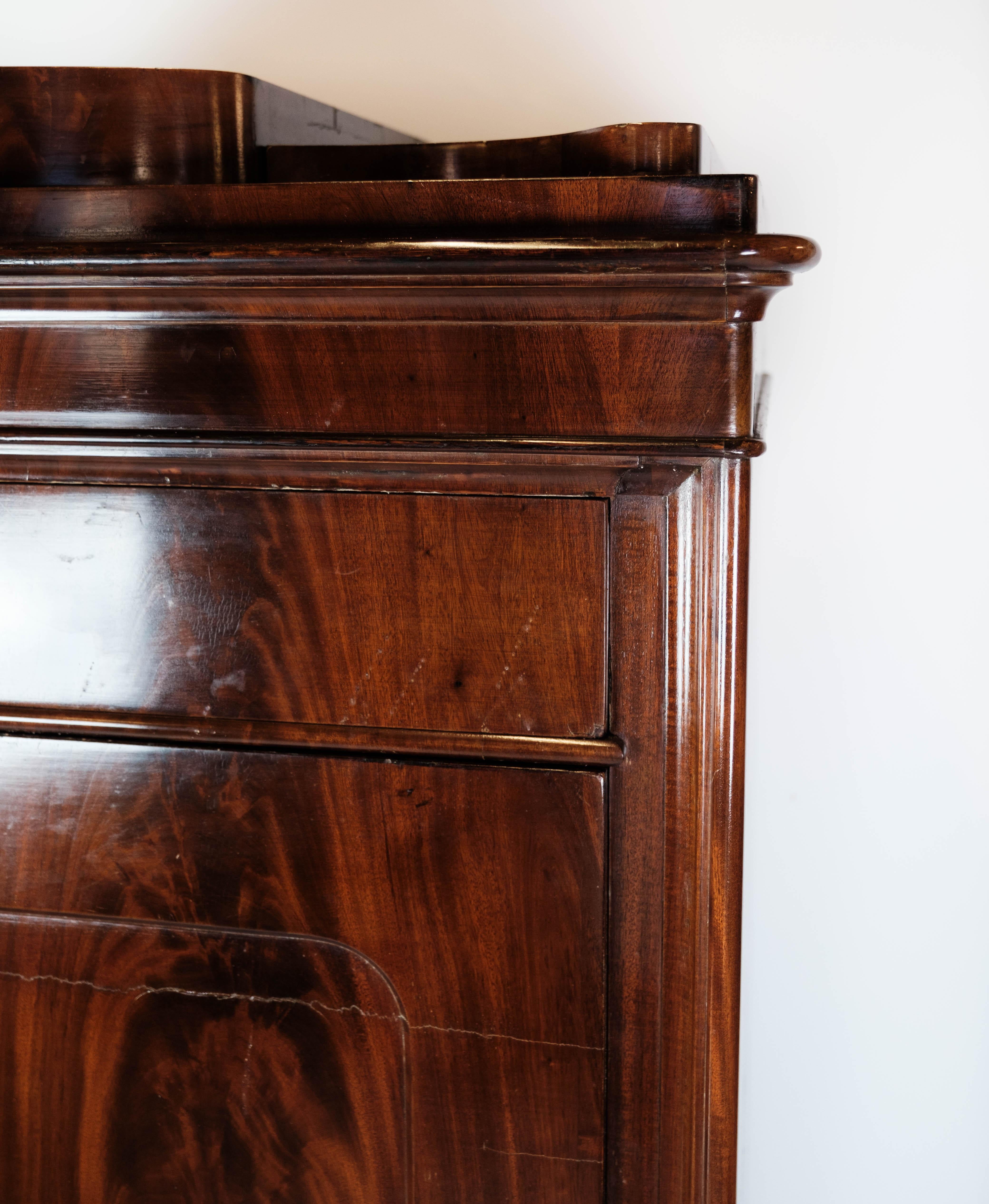 This exquisite secretary, crafted from rich mahogany with intricate inlaid wood details, showcases the elegance and craftsmanship of the 1840s. With its timeless design and impeccable antique condition, this piece exudes sophistication and