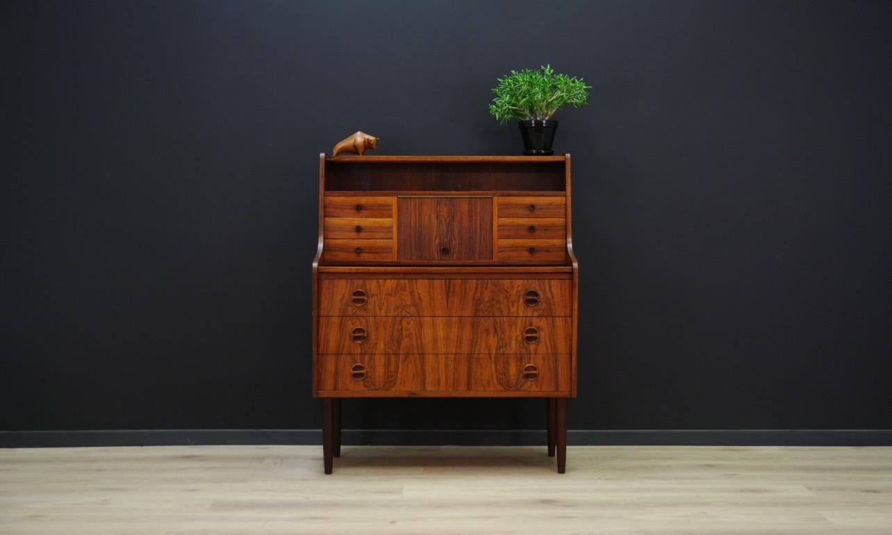 Sekretrzyk from the 1960s-1970s, Danish design, the whole finished with rosewood veneer. Secretary with many drawers, a mirror and a helpful pull-out counter top. Preserved in good condition (small bruises and scratches), directly for