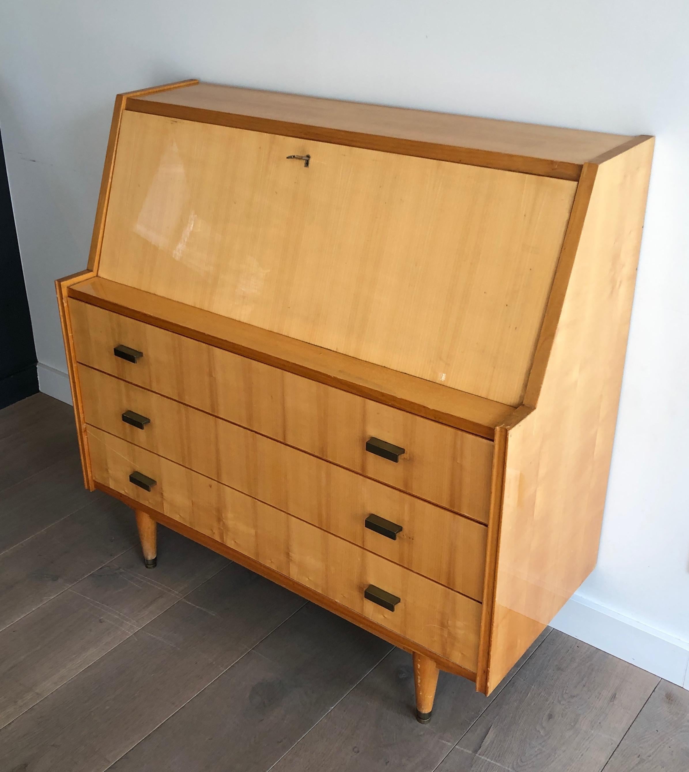 This unusual secretaire desk in sycamore with bronze handles is composed of a small sloping desk with flap closing on four drawers and forming a chest of drawers with three drawers in the lower part. This is a French work. Circa 1970