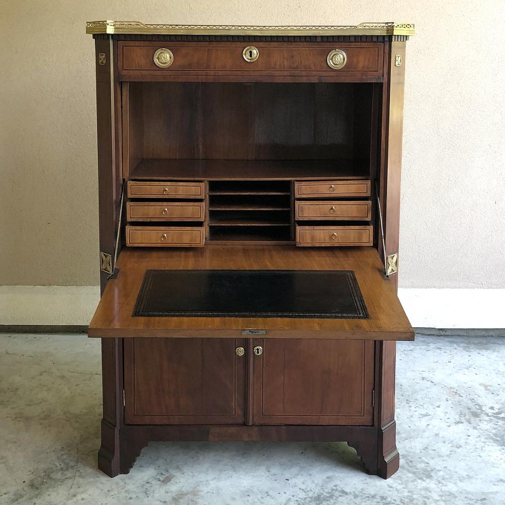 19th century French Louis XVI inlaid mahogany secretary features a tailored elegance that cannot be denied! Pierced rail around the top complements the cast brass accents, pulls and keyguards below. Fine french inlay bordering using rosewood and