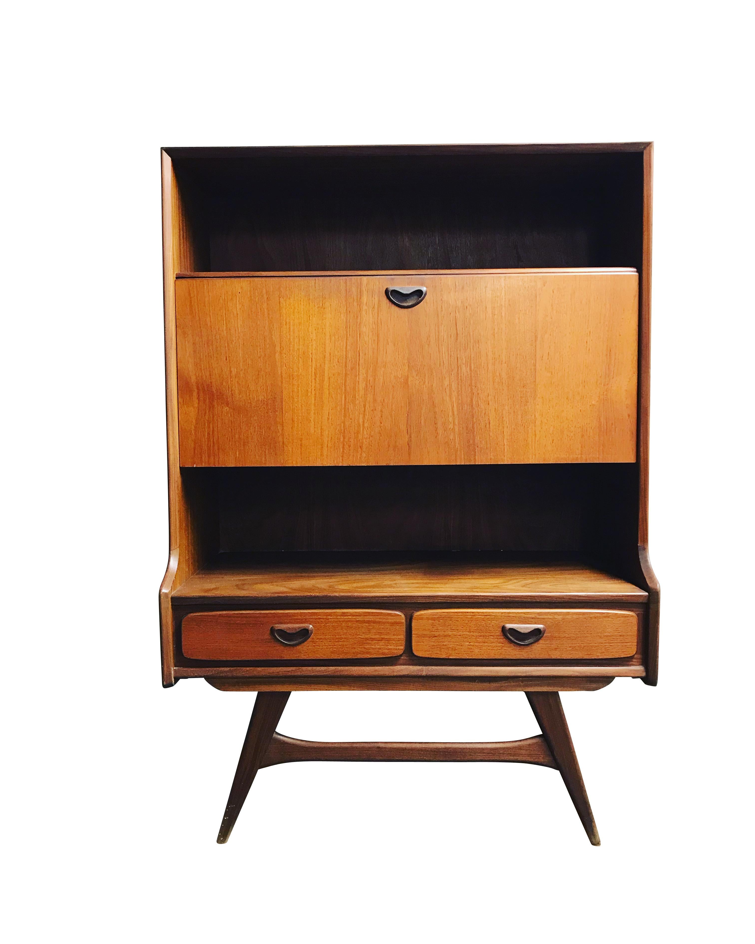 This teak secretary/bar cabinet was designed by Louis van Teeffelen during the 1960s and was made by Wébé in the Netherlands. It features an open top compartment, a middle storage space with two shelves and two drawers.

Beautiful design with