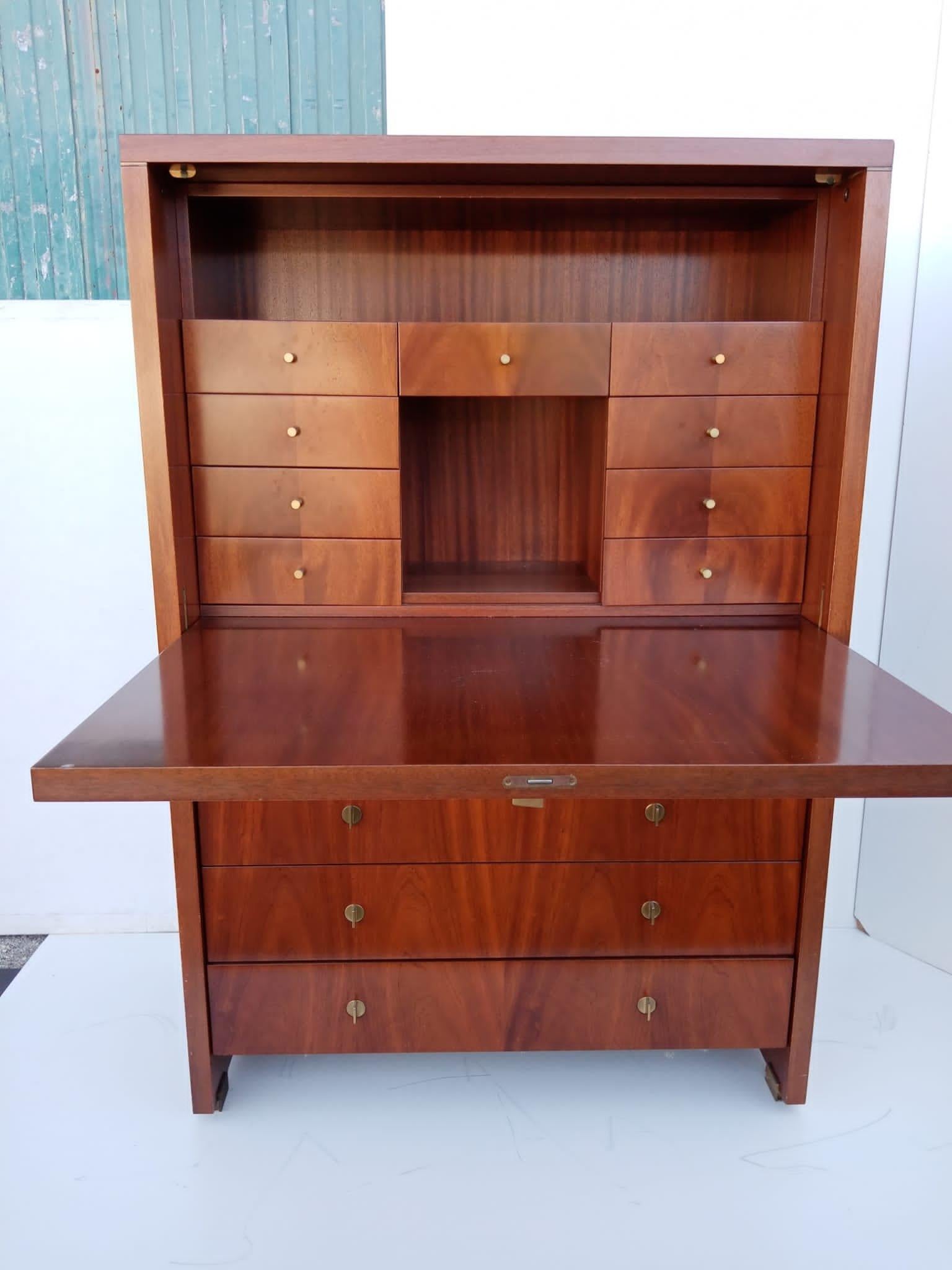 Elegant secretaire designed by French original Pierre Balmain in the 1980s.
The cabinet is easily transformable thanks to the flap door, which opens to provide space for a small desk. It is made of noble wood.
Inside are several drawers and storage