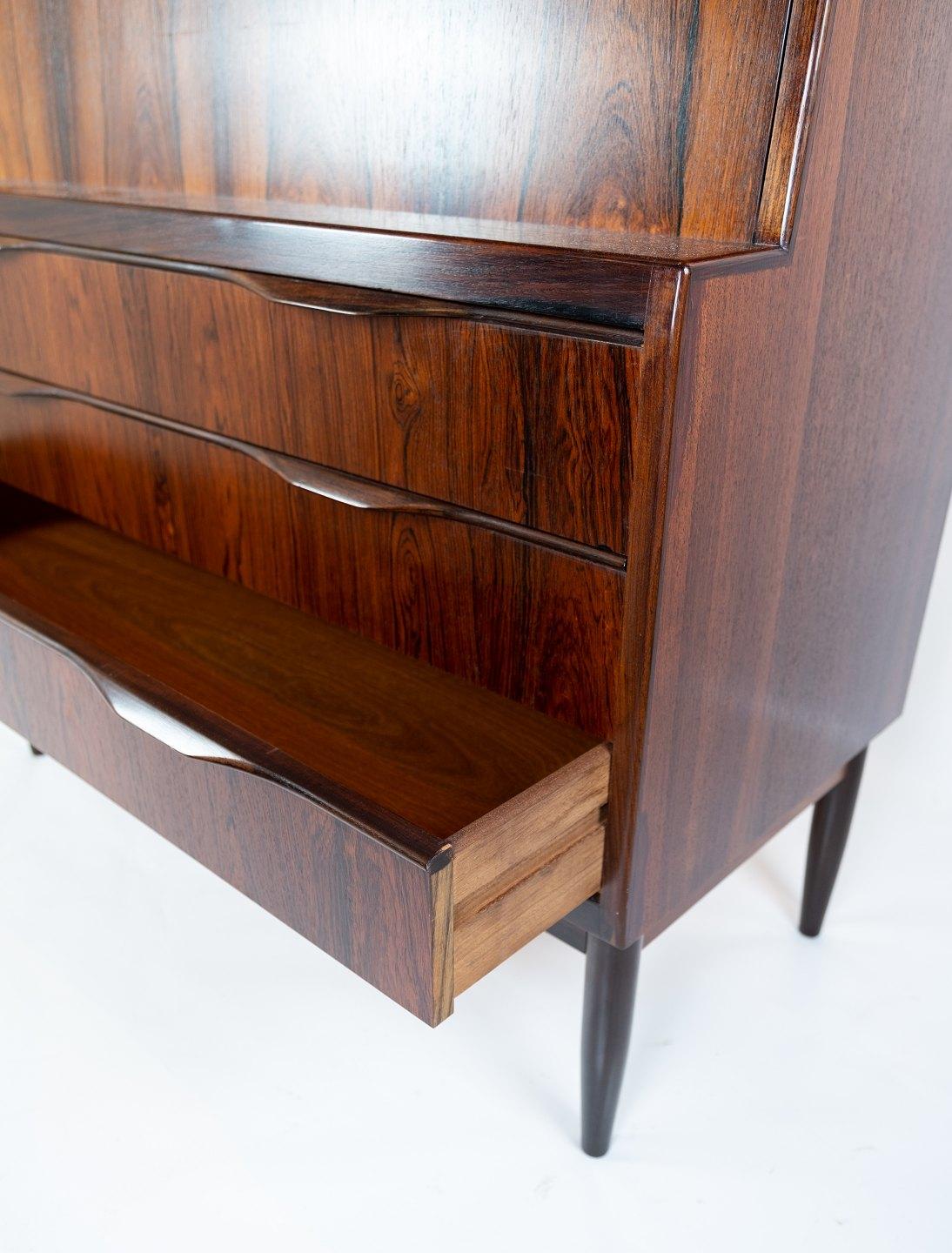 
This secretary, crafted in rosewood and showcasing Danish design from the 1960s, epitomizes both functionality and aesthetic appeal. With its sleek lines and rich wood grain, it exudes a timeless elegance that complements any interior decor.

The