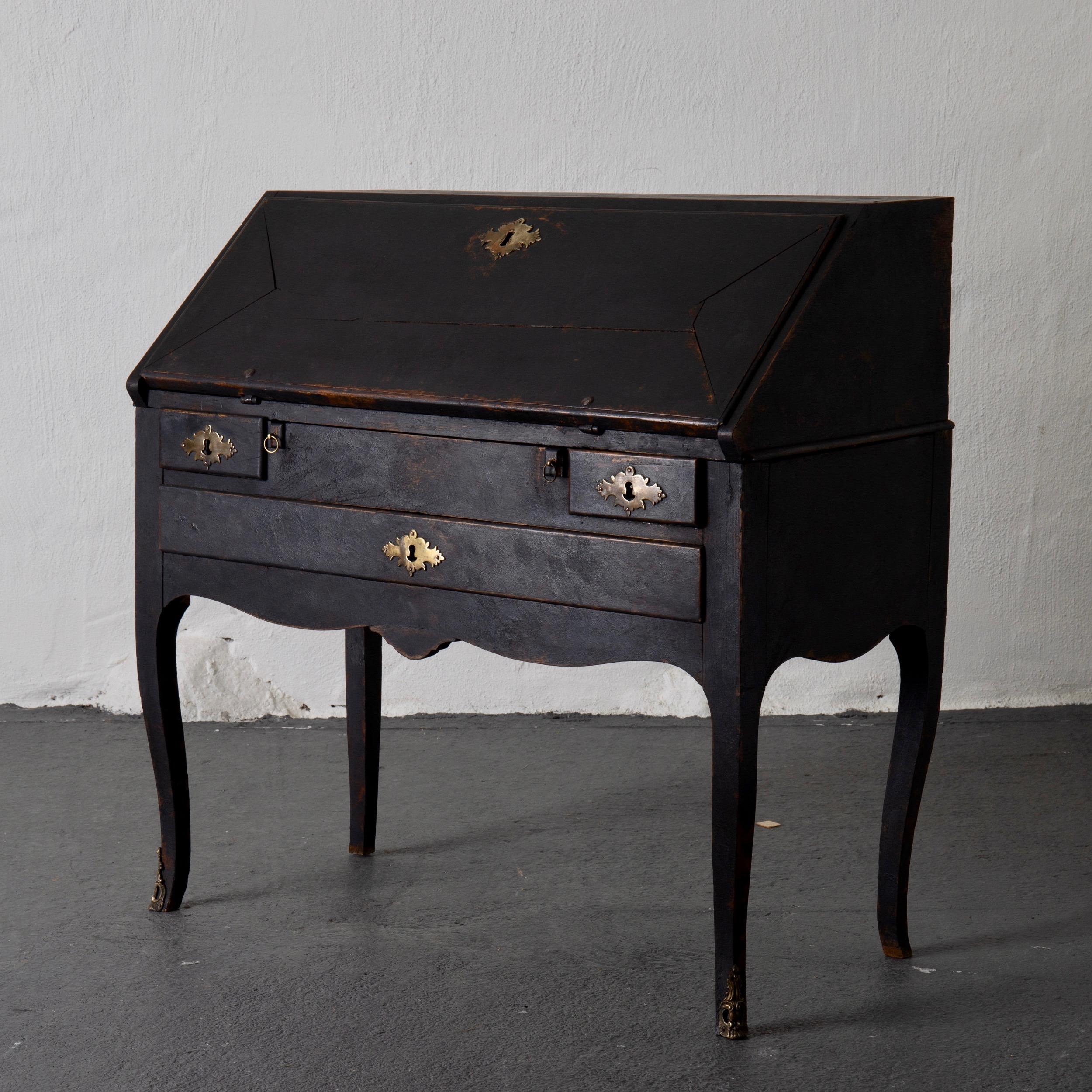A secretary made during the Rococo period in Sweden, 1750-1775. Painted in our Laserow Black. Beautiful brass hardware and casters. Interior with compartments and drawers. 

 