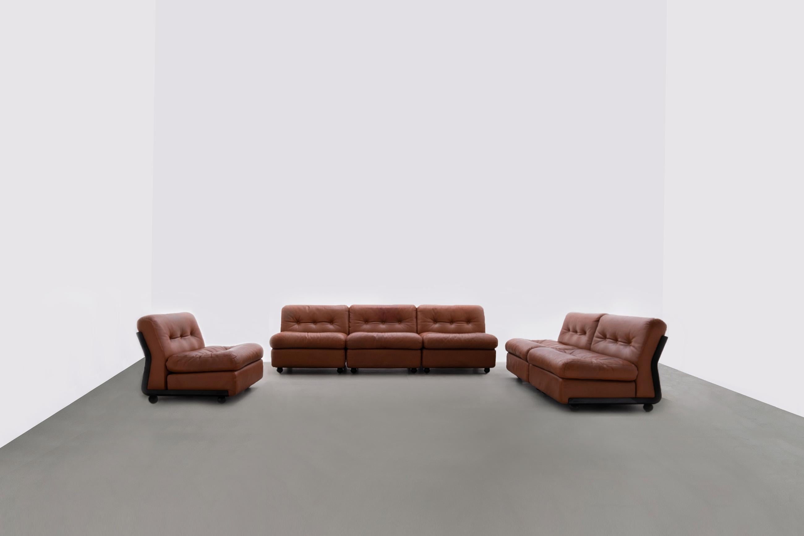 Sectional 'Amanta' sofa set by Mario Bellini for B&B Italia, Italy 1966. Black fiberglass seating shells and original cognac leather cushions. Each section can be connected to each other or placed separately as an easy chair, makes it a very playful