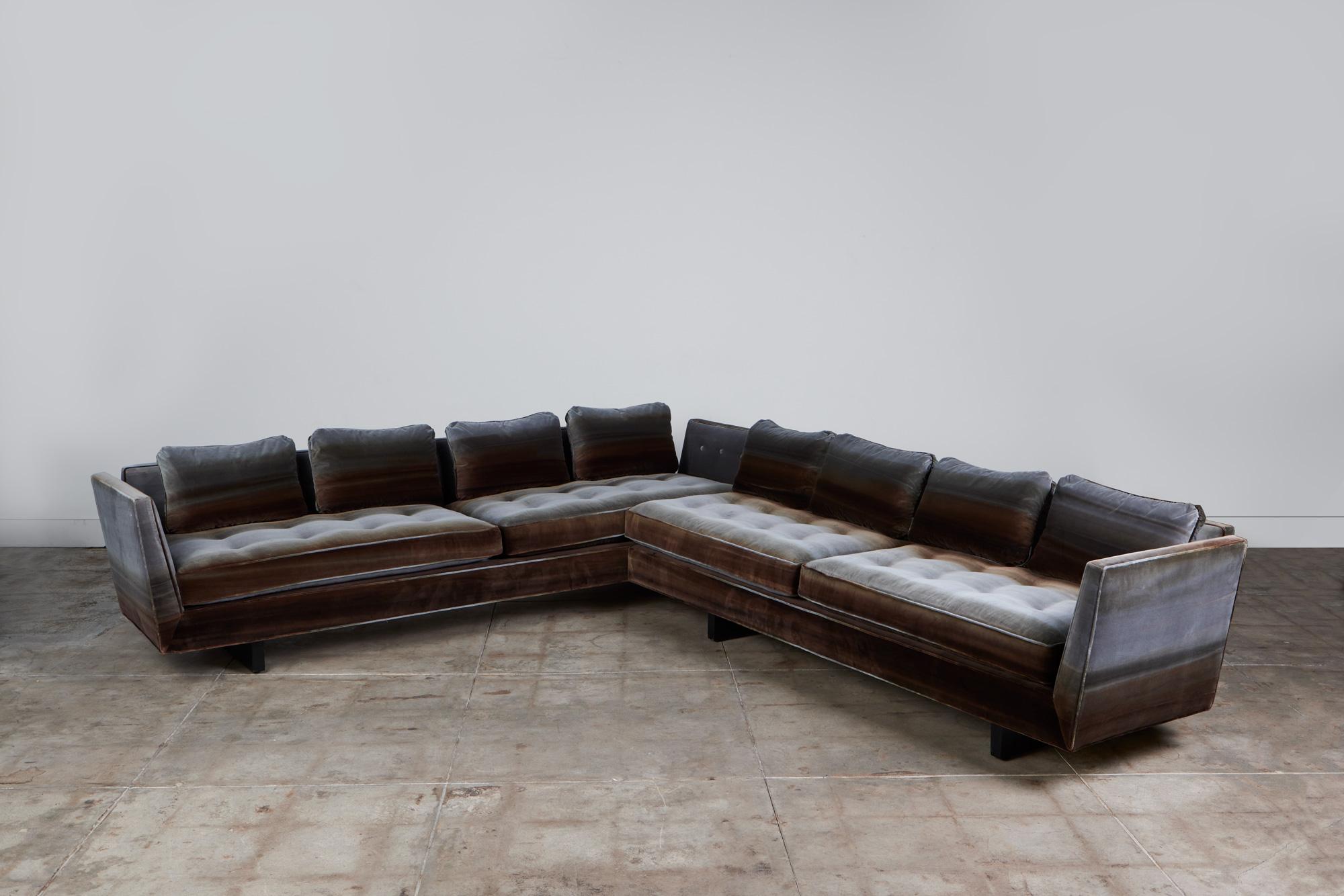 Edward Wormley for Dunbar, c.1960s, USA, two-piece sectional sofa. The sofa features split arm rests and an exposed sculpted ebonized wood frame. This sofa has been fully reupholstered in the luscious Métaphores artisanal dyed Saint Germain velvet.