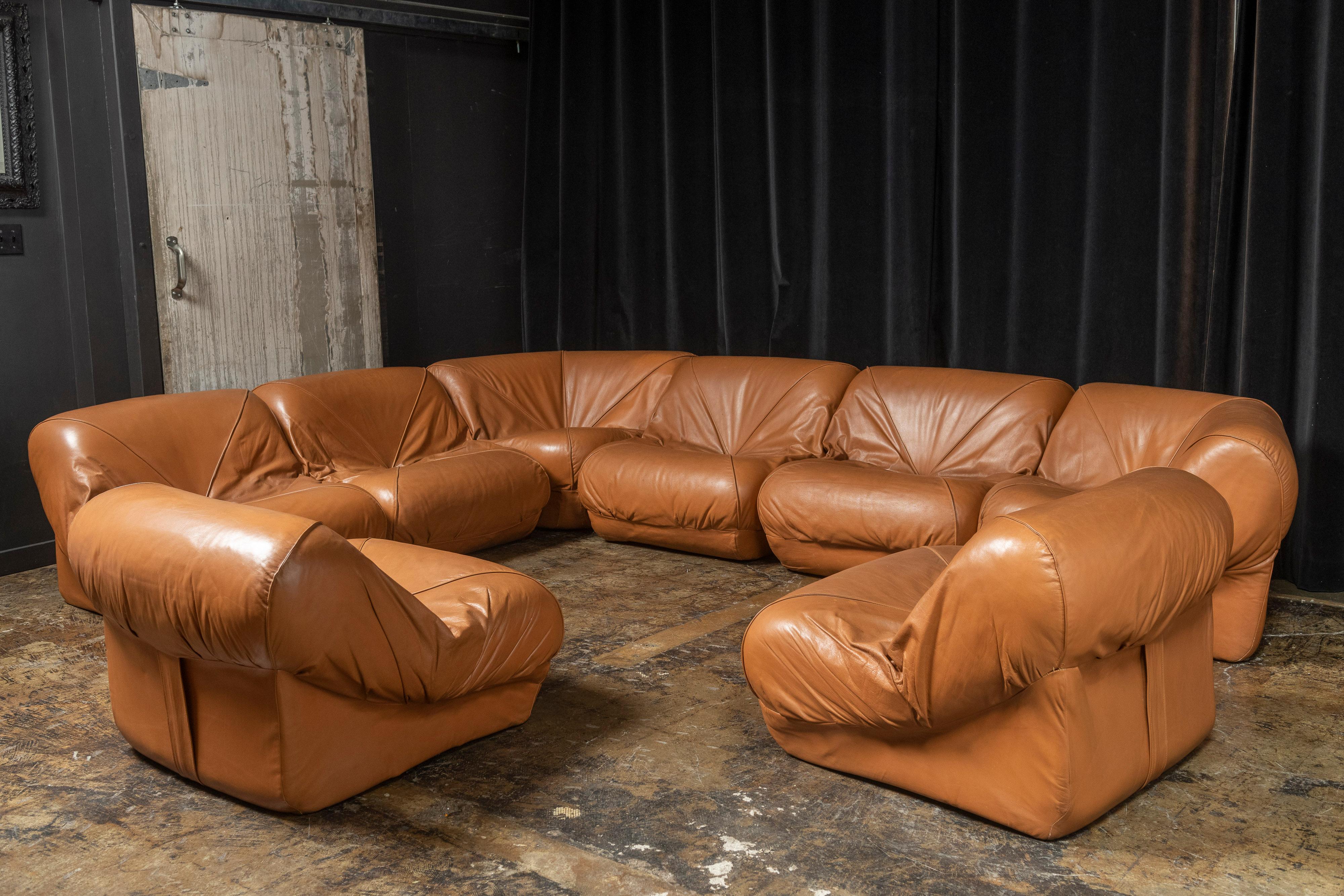 Amazing nine-piece sectional sofa by Jorge Zalszupin for L'Atelier. Seven of the pieces are similar shaped, much like slipper chairs on their own and two are triangularly-shaped, serving as a corner piece. Modular, the pieces together the sectional