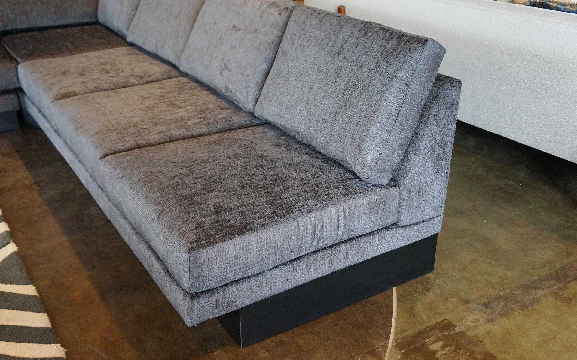 Large three-piece sectional sofa designed by Milo Baughman for Thayer Coggin. Consists of a pair of three-seat armless sofas and a corner piece making for any number of configurations beyond the obvious corner L shape configuration. Three-seat sofa