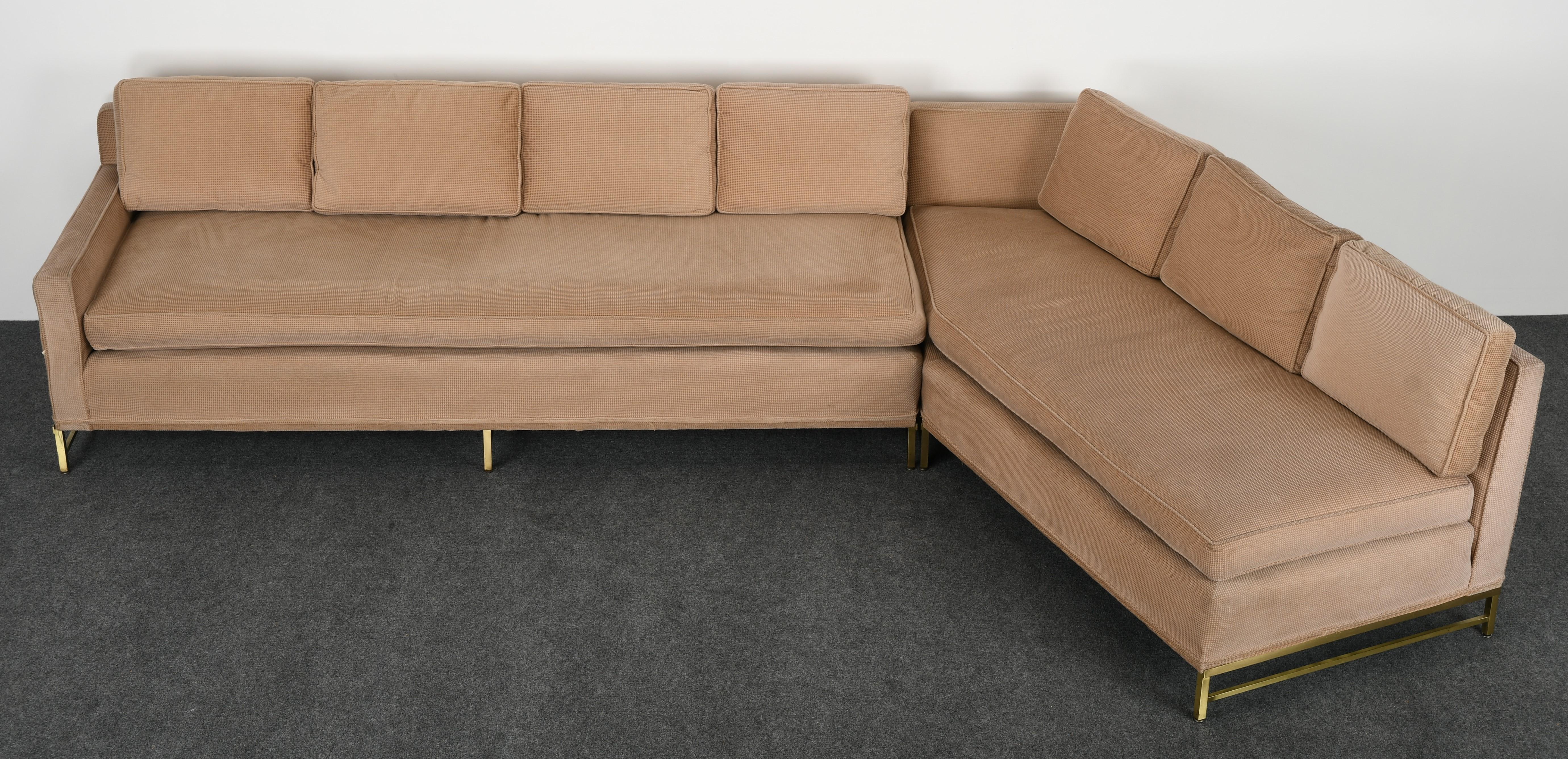 A modern two-piece sectional sofa by Paul McCobb for Directional. This room divider sofa forms an open angle seating group with brass leg bases. Sofa model number 8018-L. Left Arm Loveseat model number 8004. Solid Brass legs - some brass needs