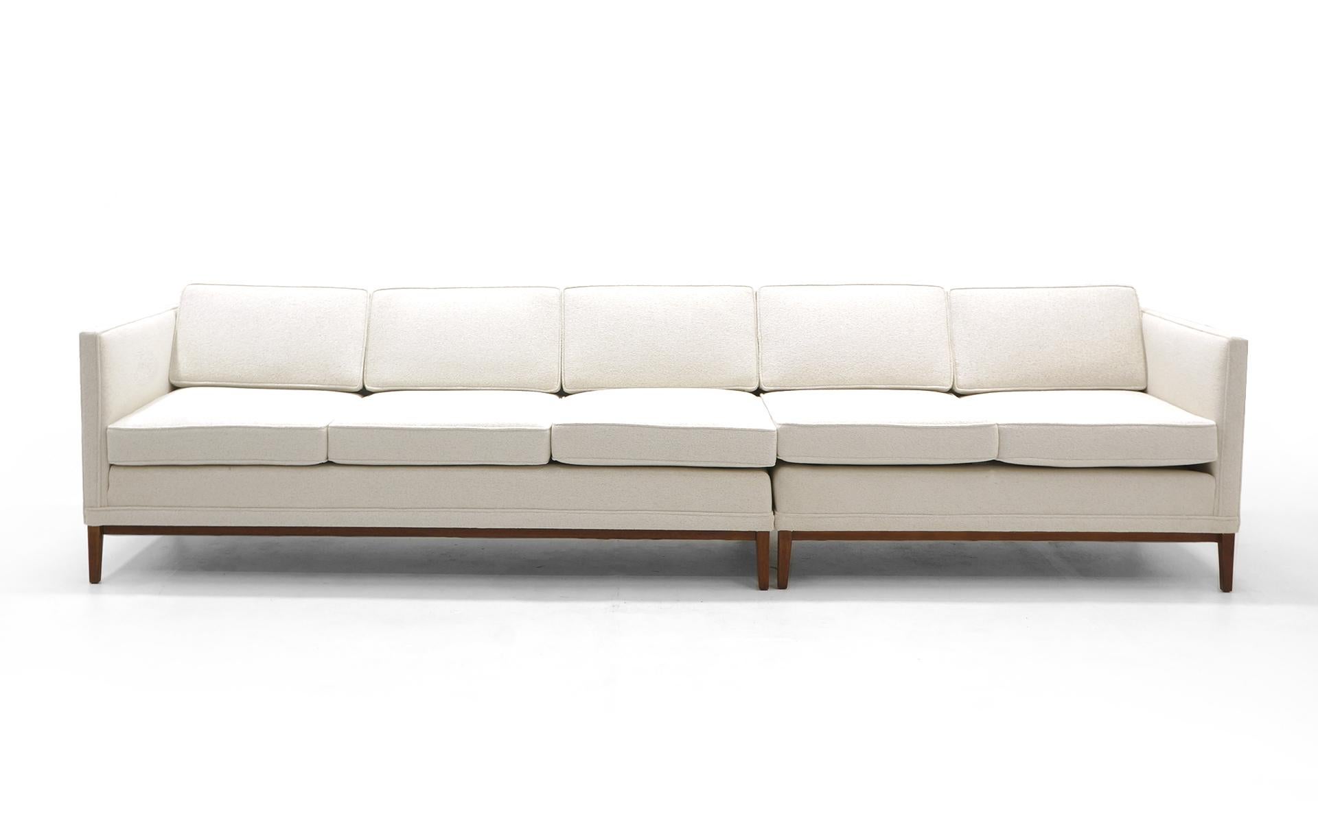 Sectional sofa in the style of Edward Wormley for Dunbar. Even arm, elegant design. Expertly restored and reupholstered in an off white HBF Textiles Merci bouclé. As you see in the photos, these can be used as an L shape or together they make a sofa