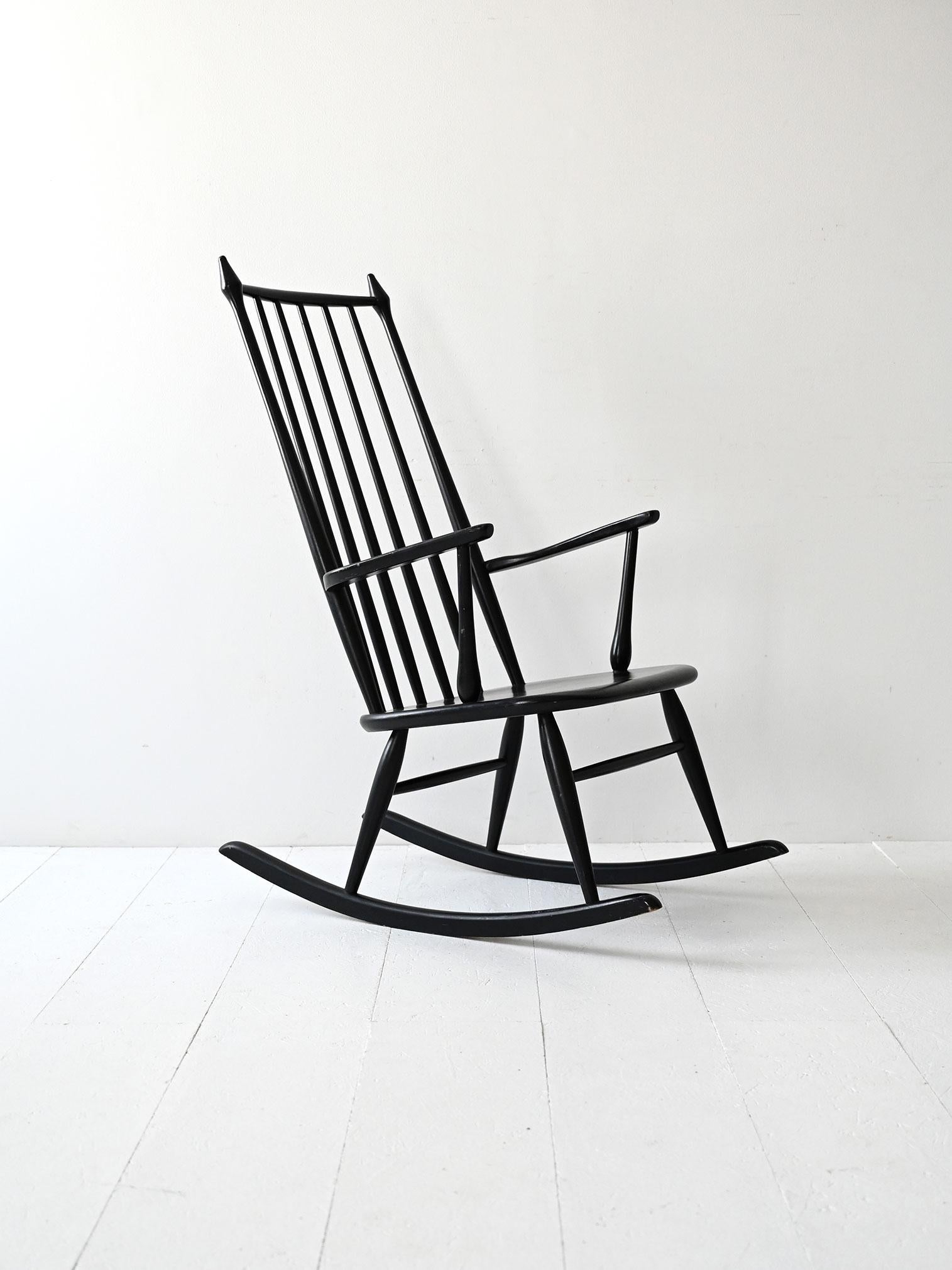 Fauteuil à bascule en bois peint en noir, production danoise des années 1950/60 inspirée du modèle Windsor classique.

Chaise à bascule scandinave vintage en bois peint en noir, fabriquée au Danemark dans les années 1950/60. Le design s'inspire du