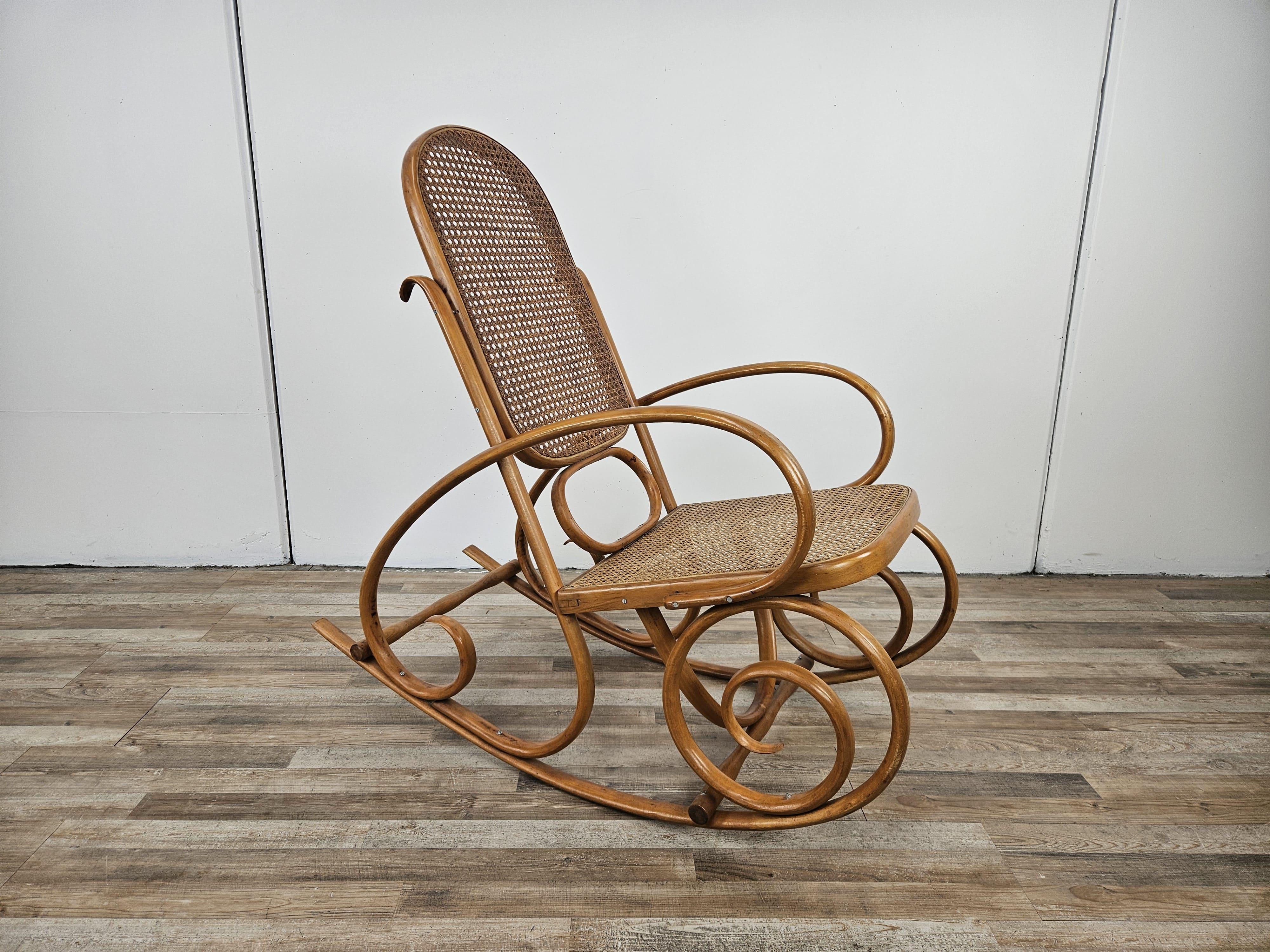 Vintage bentwood rocking chair with woven Vienna straw seat and back.

Rocker has no marks or labels, normal signs of wear from age and use.
Screws and nuts are not original but installed later in time.
