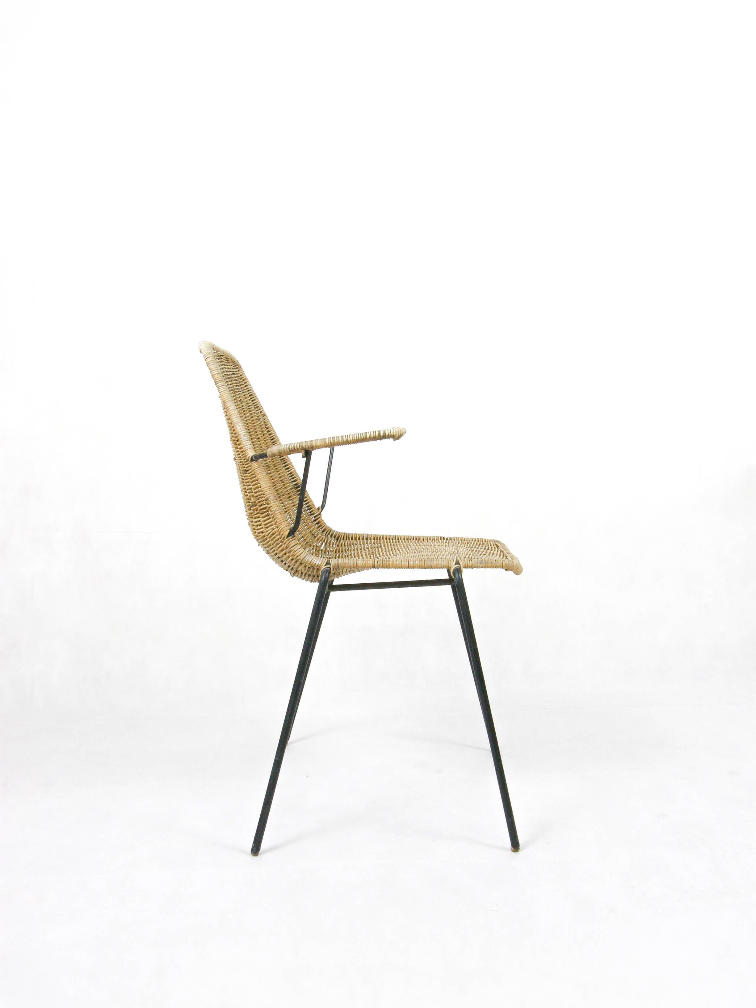 Chair with arms made of woven wicker and lacquered metal from mid-1950s Italy.
Designed by Franco Campo and Carlo Graffi and produced by their firm, 'Home Torino.

Sturdy and lightweight chair in excellent condition. 
Cozy and comfortable seating.