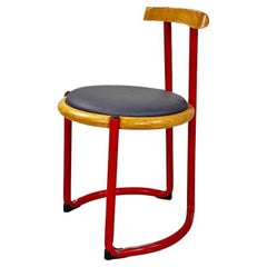 Italian chair by Tito Agnoli in red metal, wood, and faux leather, ca. 1960.