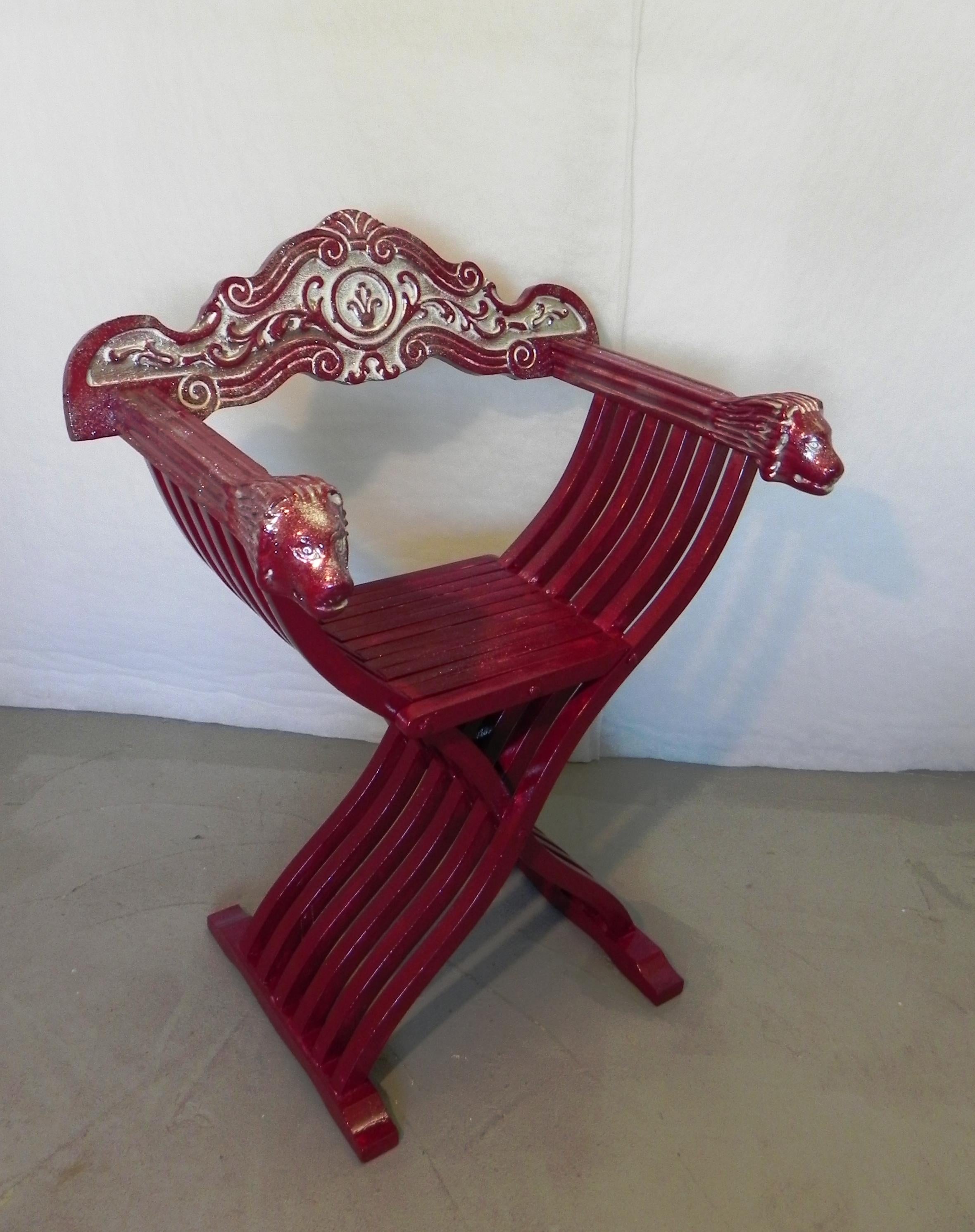 savonarola Red Throne chair. built in the 1960s in the renaissance style. armrests with carved lion heads. back carved with renaissance decorative motifs. the chair originally walnut color, was repainted for the purpose of use in a theatrical piece,