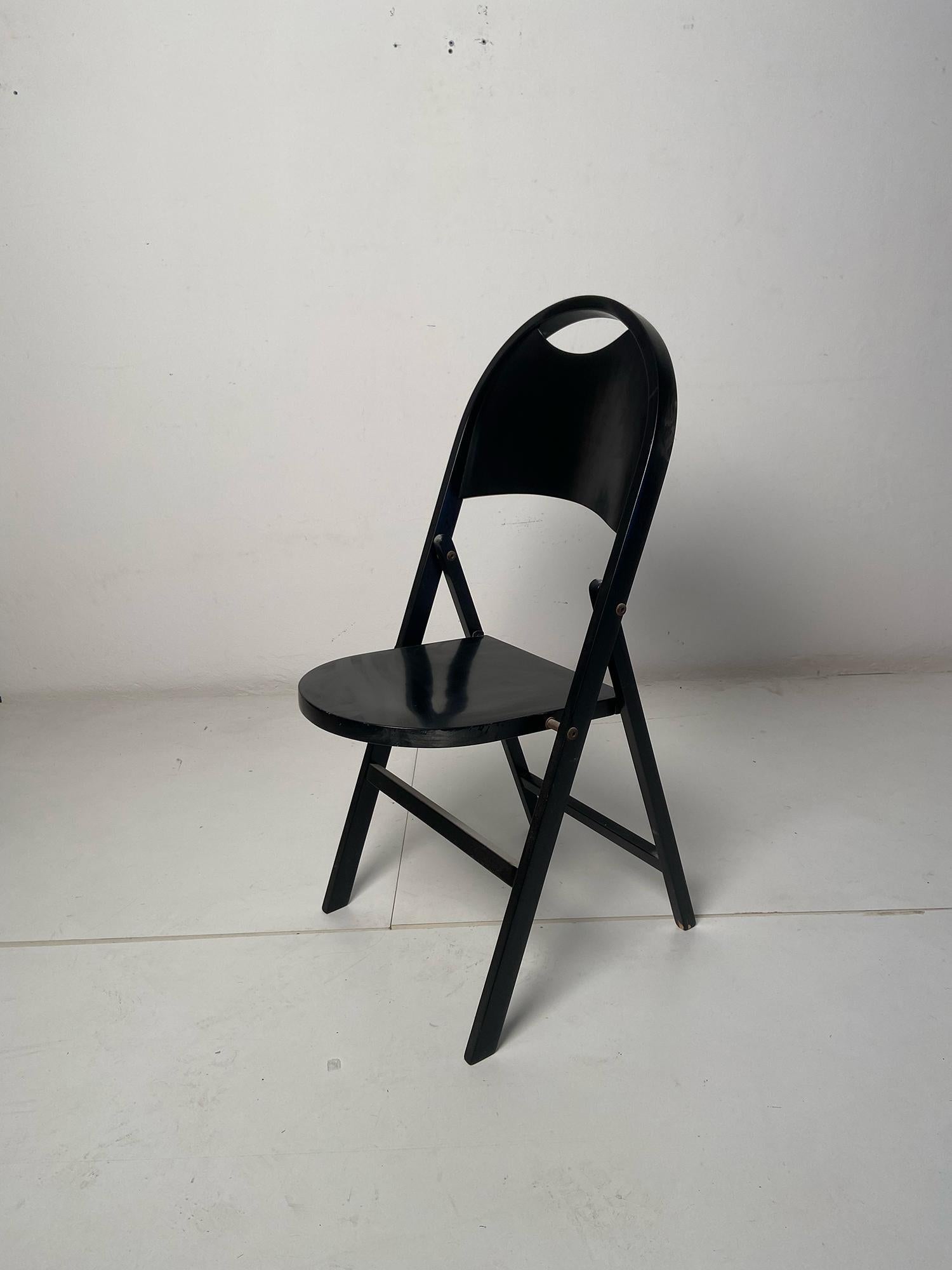 Tric Stuhl, entworfen von Achille und Pier Giacomo Castiglioni und hergestellt von Bernini in Italien in den 1960er Jahren. Tric ist ein leichter und praktischer Klappsitz, der vollständig aus schwarz lackiertem Holz besteht. Sitz und Rückenlehne