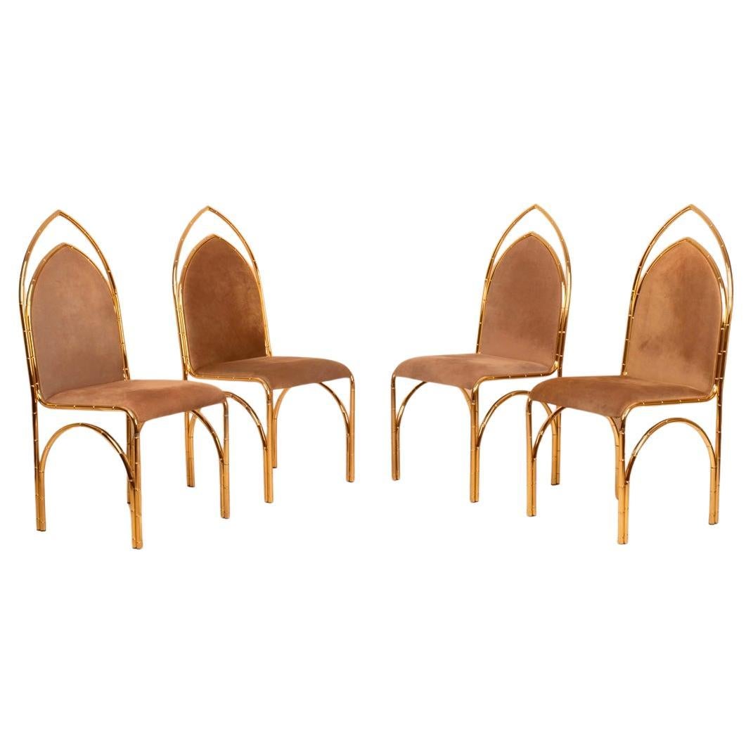 Stunning set of four dining chairs crafted in Italy during the 1970s, featuring bamboo-effect brass frames and upholstered in luxurious suede. These chairs exemplify the elegance and material richness typical of Italian modernism of the era.

The
