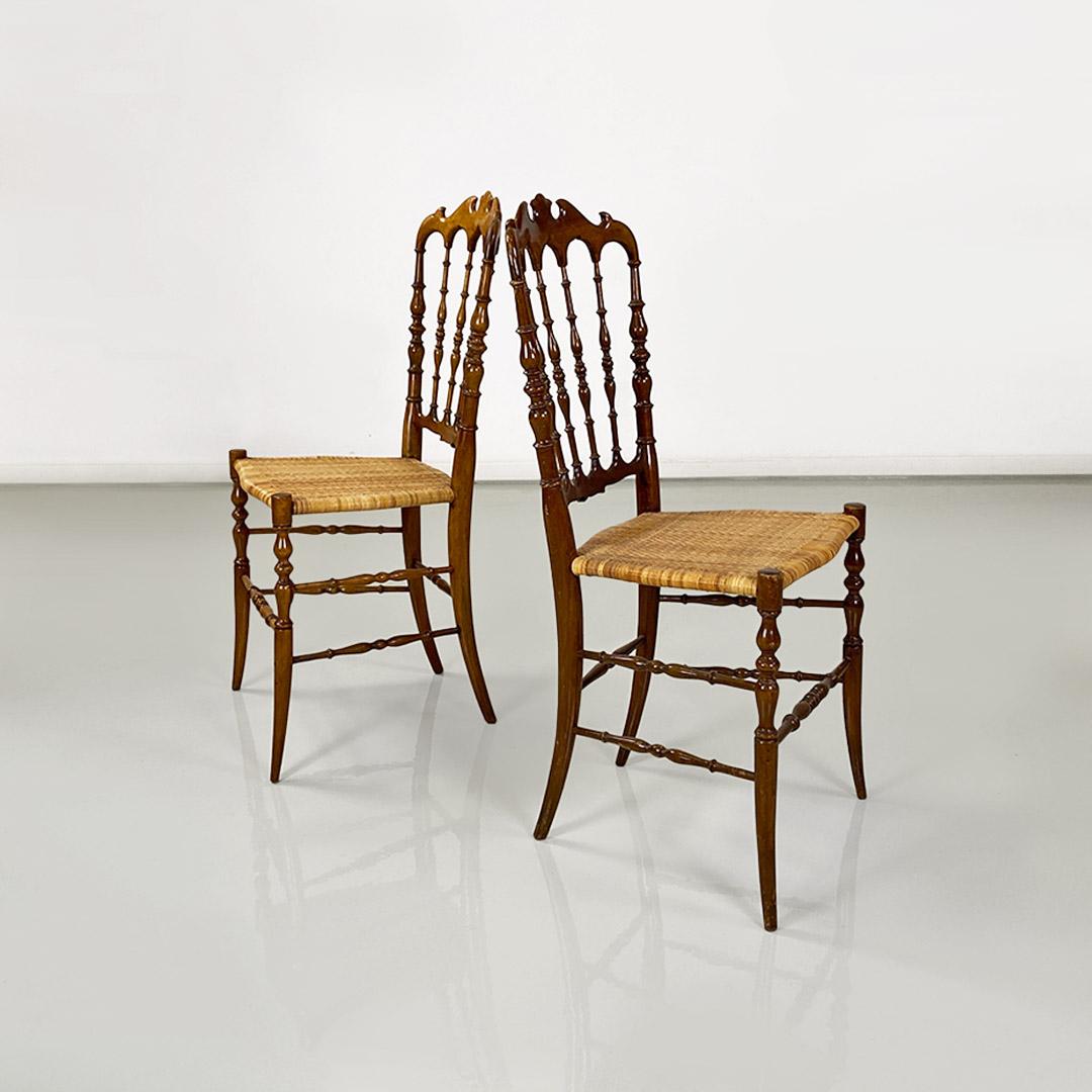 Pair of Chiavari model chairs made of walnut wood and original woven wicker seat, with turned strips on the back.
One of the two chairs has a darker coloring than the other because of the light taken in over the years.
Produced by Colombo Sanguineti