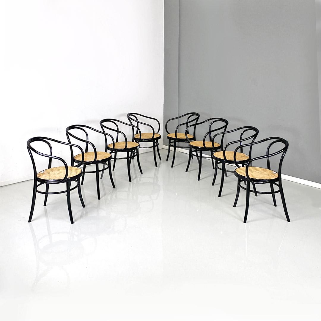 Set of eight model 209 chairs, with curved beech frame painted black, with ring also made of curved wood placed under the round seat to reinforce the frame, acting as a connector between the four legs and Vienna straw seat.
Chairs from a