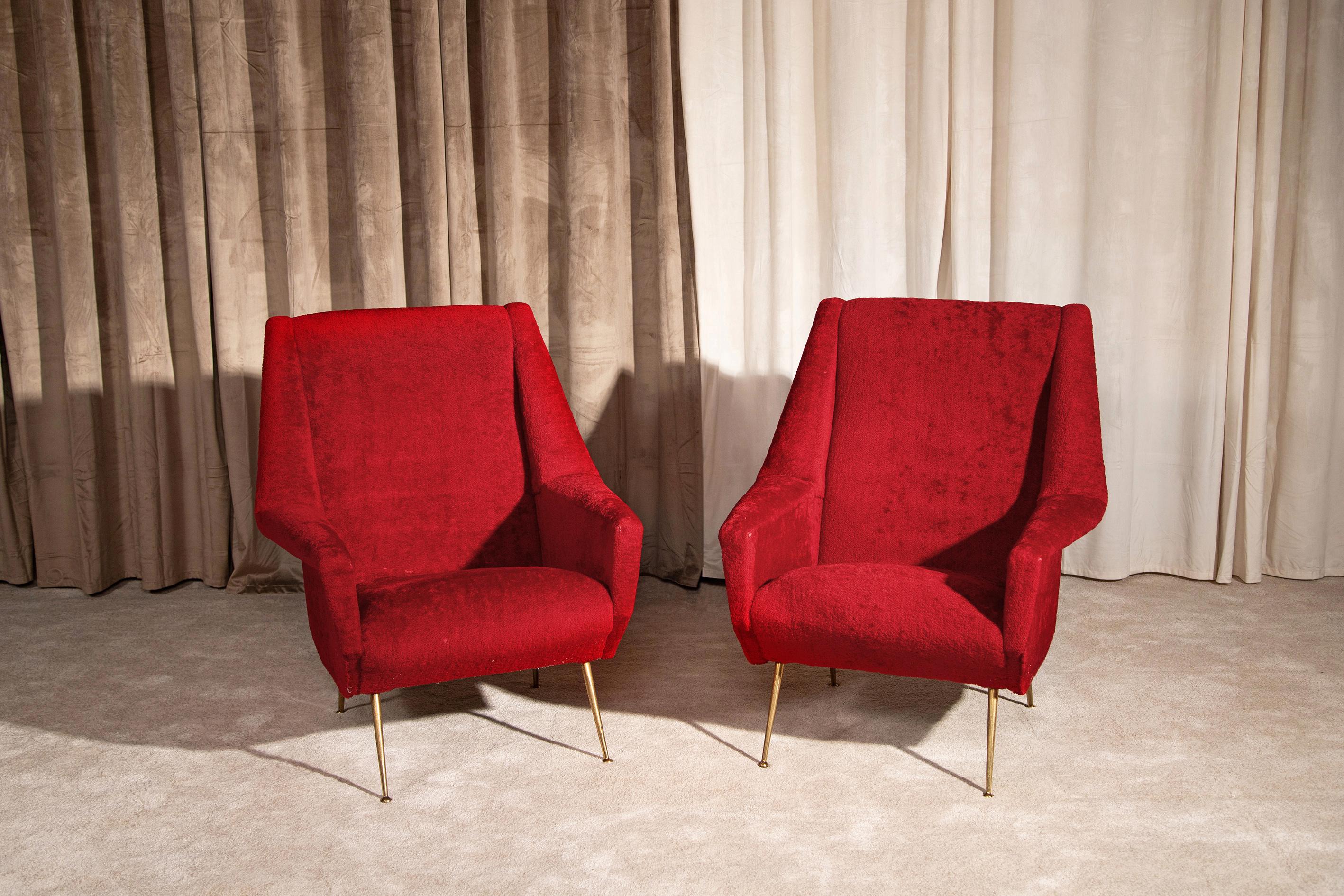Elegant pair of 1950s Italian-made armchairs lined in red bouclé fabric (original of the period). Overall condition is excellent, with very slight signs of time and use. The shape is elegant and nontrivial thanks to the trapezoidal line of the