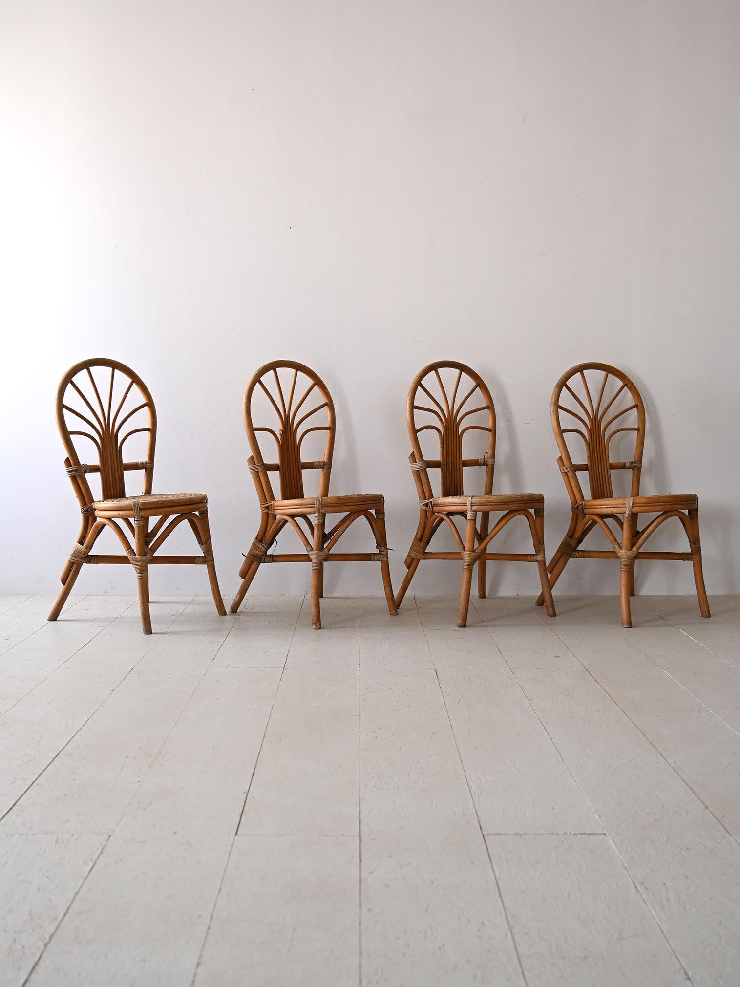 Set of four vintage chairs made of bamboo, embodying the elegance and charm of natural furniture.

The chairs feature soft, curvy shapes that give them a cozy and comfortable look. The round seat and upturned U-shaped backrest are both made from