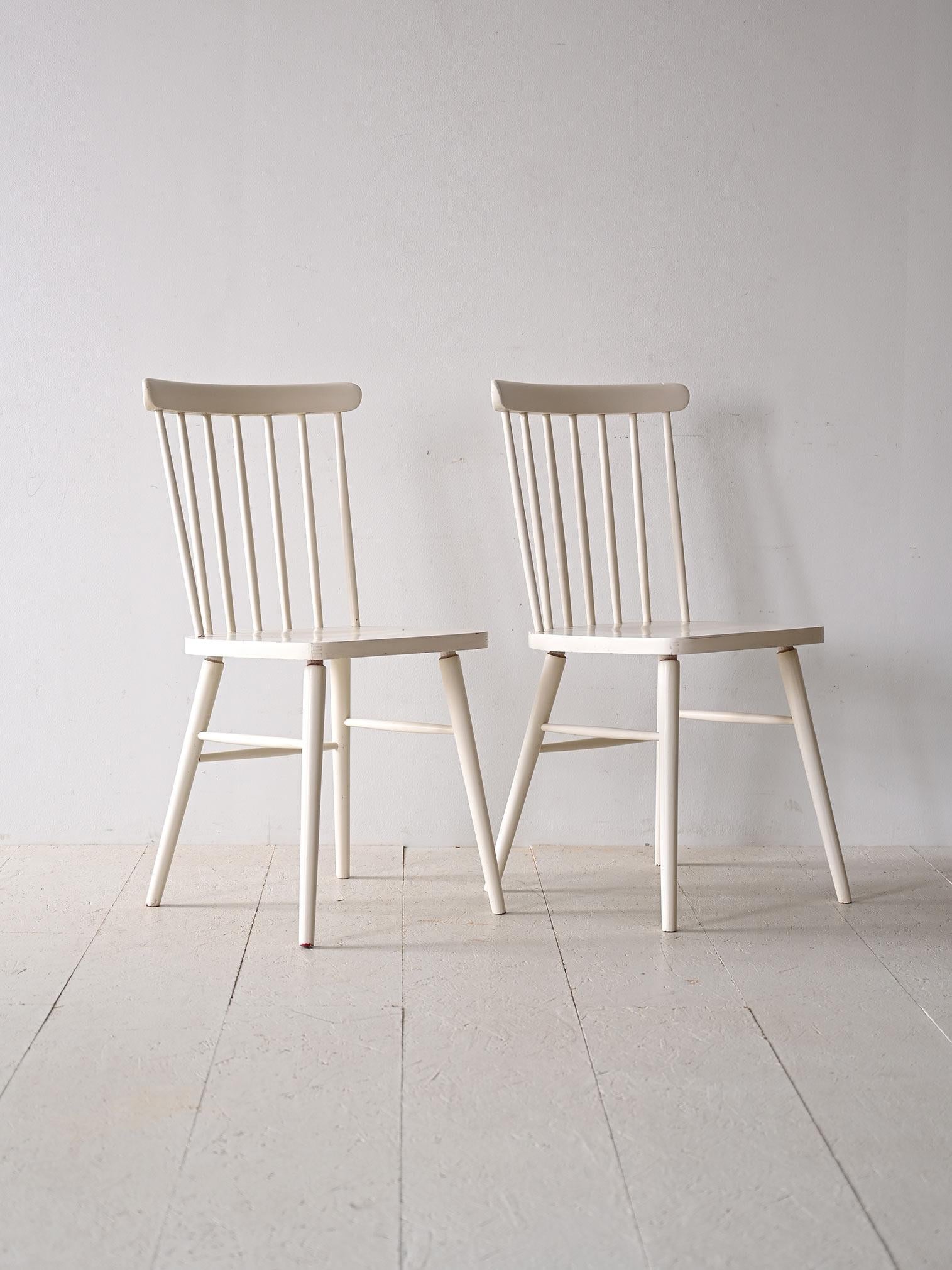 Pair of two original vintage wooden chairs.

This seating model, which has become known worldwide, is still in production today as its design is extremely current. It features minimal, elegant lines and an ergonomic seat thanks to the contoured