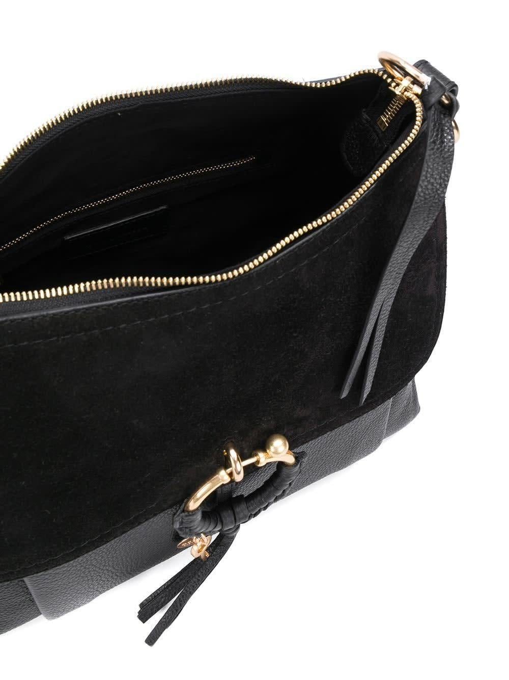 This Joan hobo bag by See By Chloé is made of black calf leather and features a detachable and adjustable shoulder strap, a top handle, a top zip fastening, gold-tone hardware, a tassel, an engraved logo charm and a braided detail, an internal zip