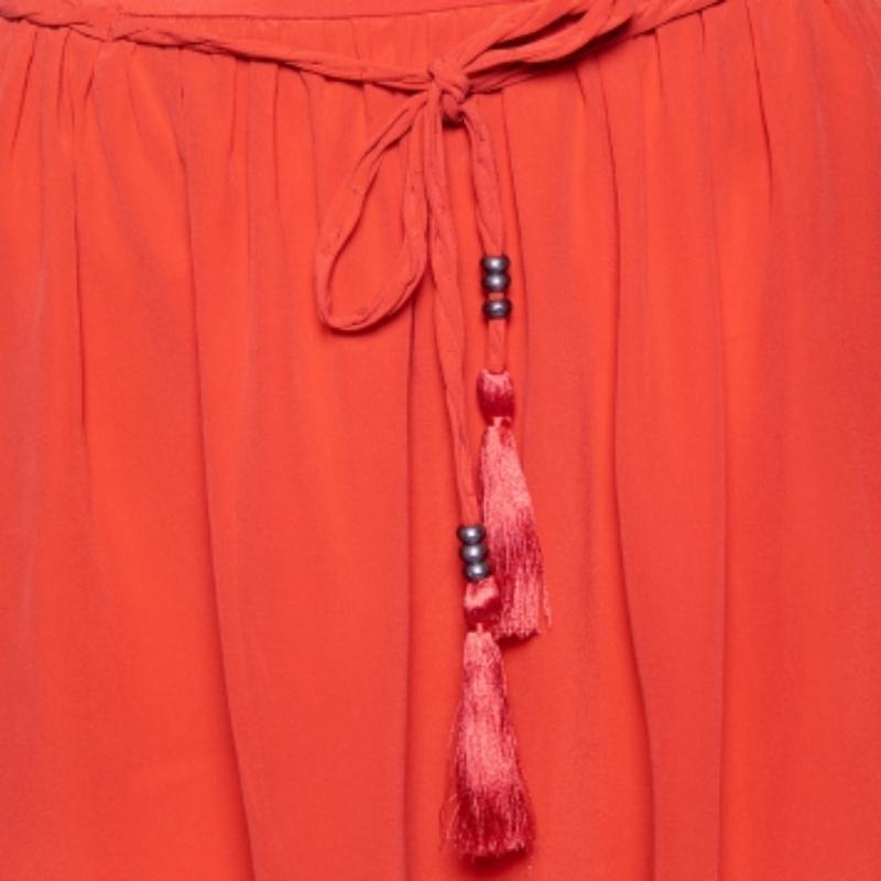 Whether it's your beach vacay or a casual summer outing, this skirt from See by Chloe is a beautiful outfit choice that will make you look trendy! It is tailored using coral-pink silk fabric and comes with a braided tassel belt. It has a zip closure