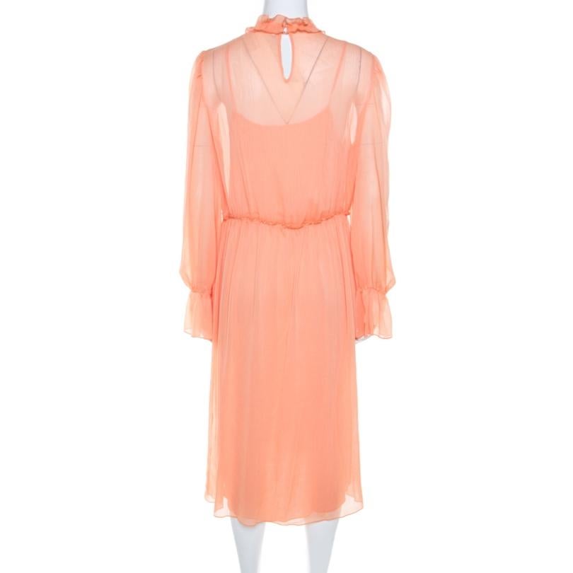 This orange dress is from See by Chloe. This dress wins with its feminine design of floral appliques, ruffled trims, and midi hemline. It has sheer long sleeves and a gathered waist which fine-tunes the otherwise straight silhouette.

Includes: The