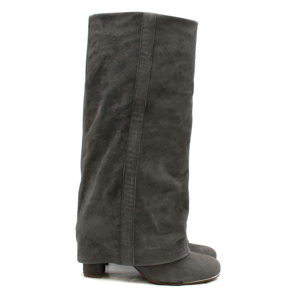 See by Chloe Grey Suede Heel Covered Boots

-Grey, suede exterior
-Flap-over style
-Heeled
-Rounded toe
-Silver metal trim around toe
-Cream leather interior 

Please note, these items are pre-owned and may show some signs of storage, even when