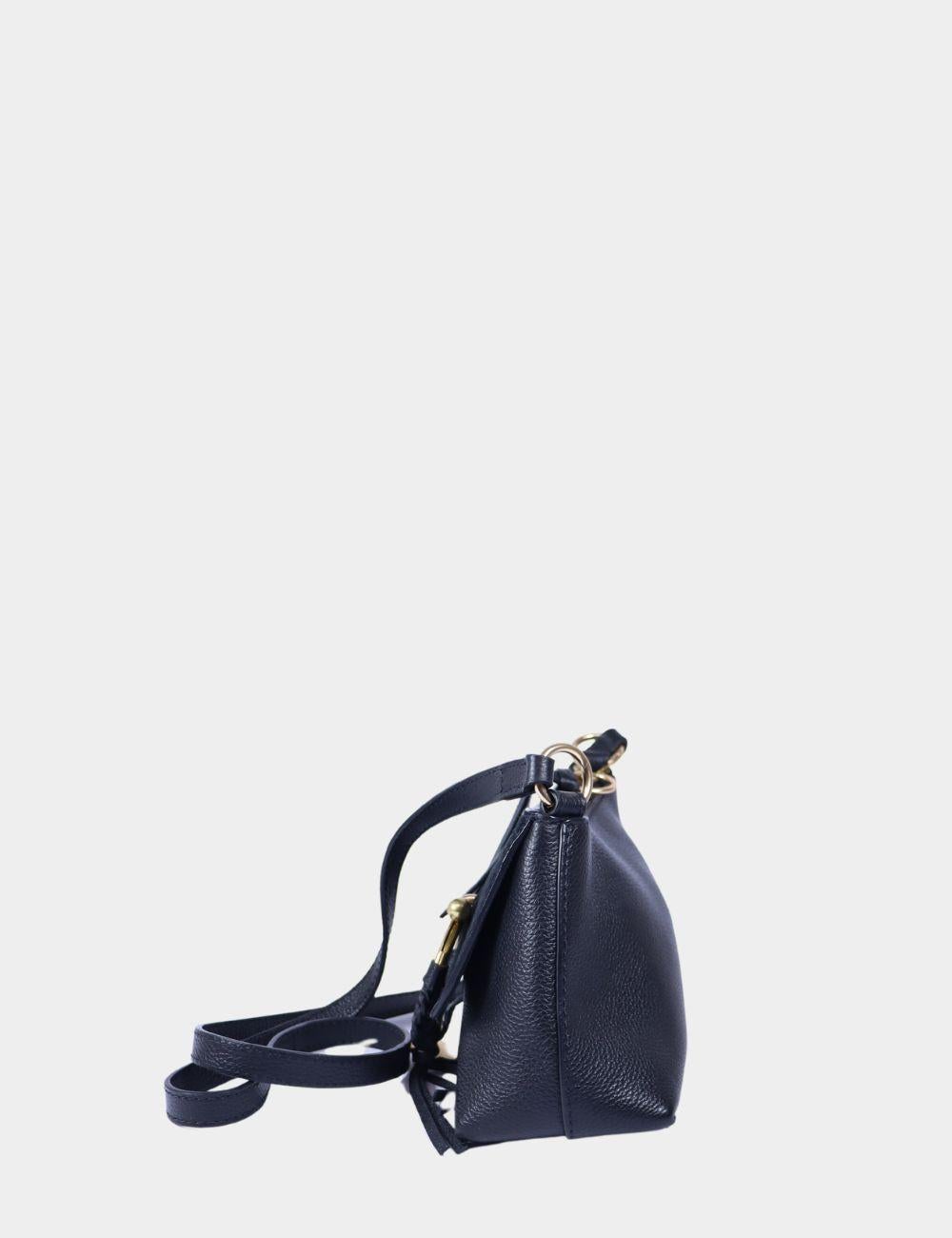 Chic and compact, the See by Chloé Hana Mini Bag is the perfect blend of boho charm and Parisian polish. Crafted from smooth grained leather and rich suede in a deep navy hue, this crossbody features the brand’s iconic braided O-ring hardware
