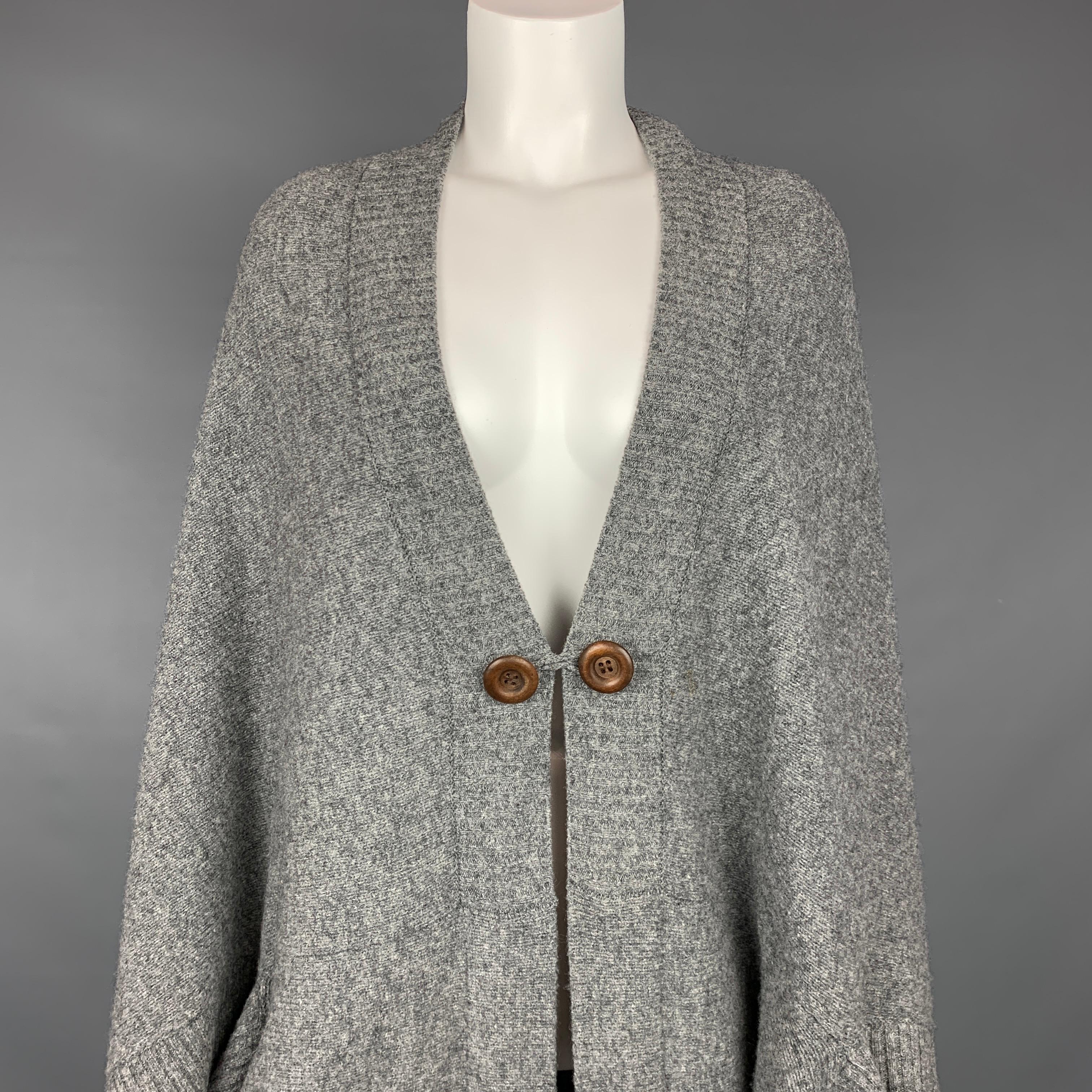 SEE by CHLOE cardigan comes in a grey knitted material featuring a circle style, 3/4 sleeves, slit pockets, and a single button closure.

Very Good Pre-Owned Condition.
Marked: No size marked

Measurements:

Bust: 42 in.
Sleeve: 3 in.
Length: 36 in. 