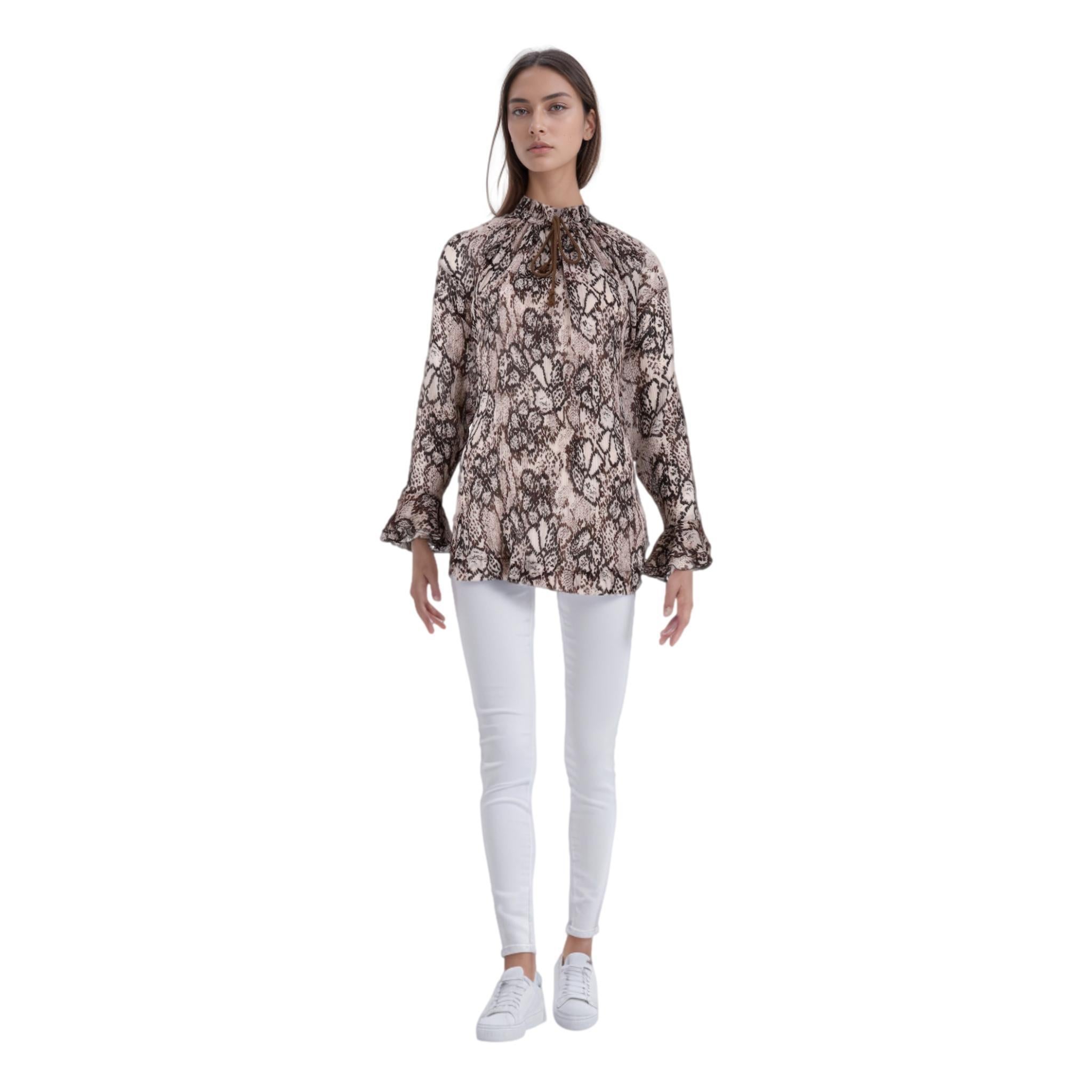 See By Chloe Silk & Cotton Chiffon Snake Print Top

Brown blouse crafted in silk and cotton chiffon with all-over snake pattern.

Featuring ruffled neckline and cuffs, a front tie fastening and relaxed fit.

Size – 38FR

Condition – Very