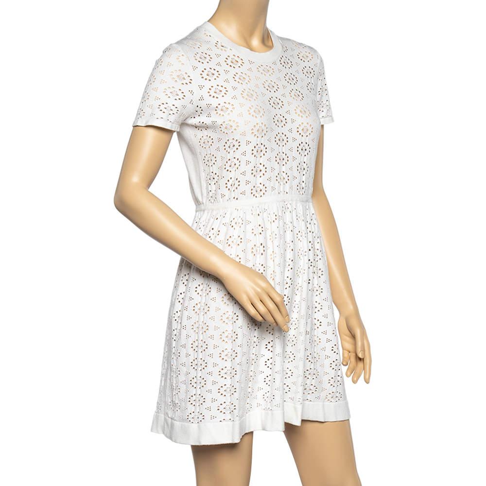 This dress from See by Chloe is a stunning masterpiece. This dress is beautifully stitched using white perforated knit fabric with a flared fit accentuating its shape. Complement this dress by matching it with white sneakers and look nothing but