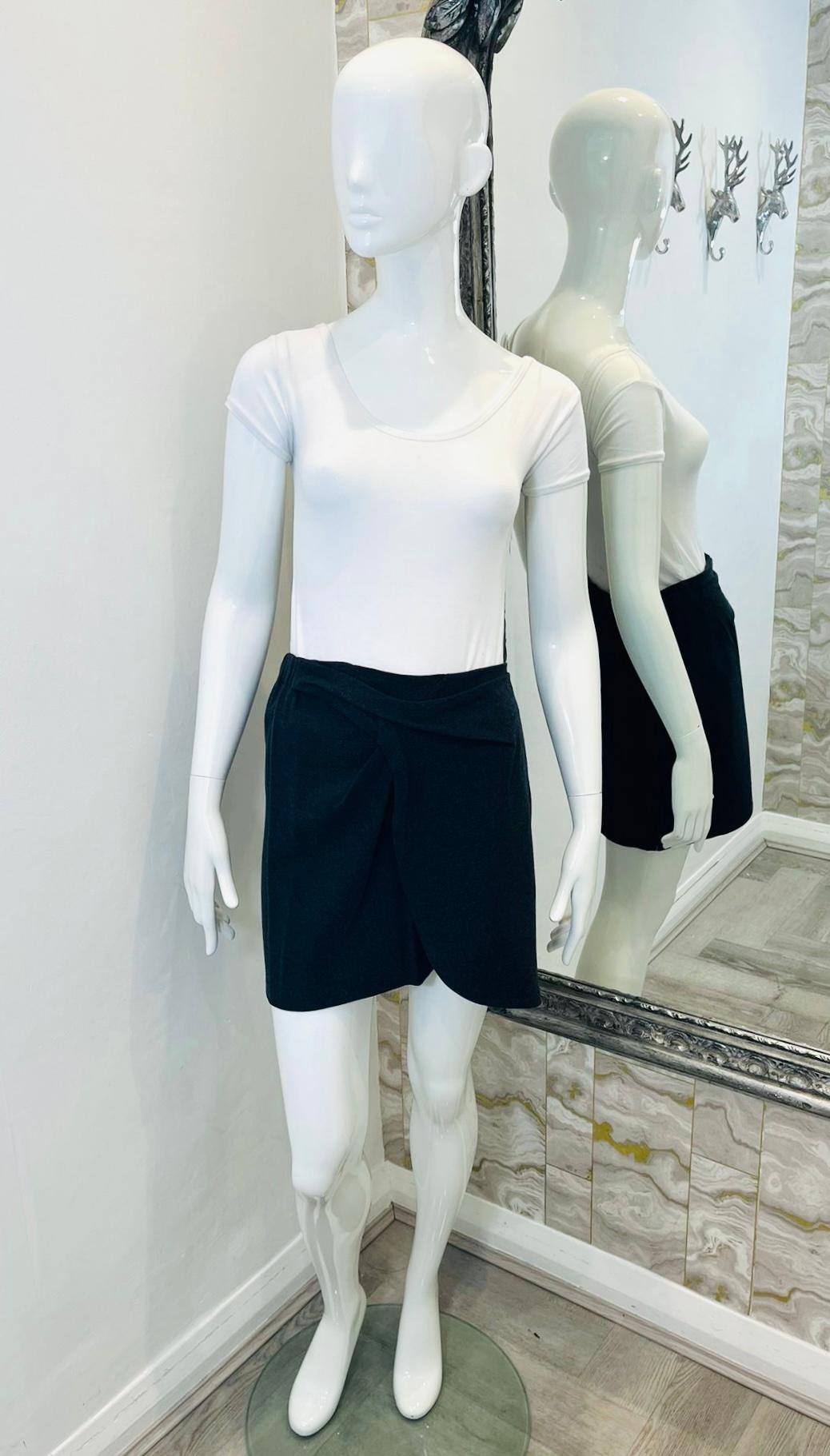 See By Chloe Wool Blend Mini Skirt

Dark grey skirt designed with wrap detailing to the side.

Featuring elasticated waistband to rear and slim silhouette.

Size – 42IT

Condition – Very Good

Composition – 68% Viscose, 29% Virgin Wool, 3% Elastane