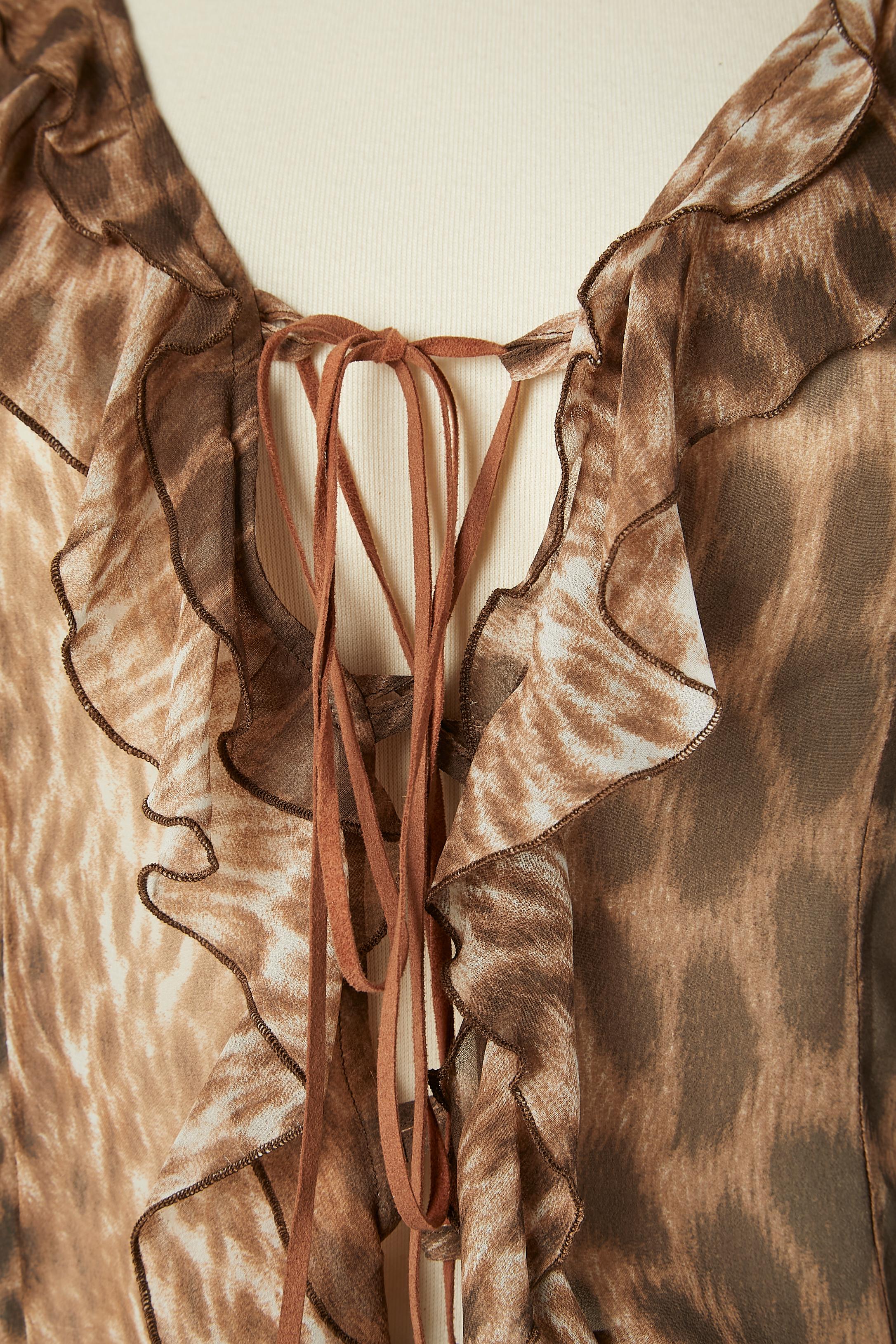 See-through animal printed top with suede laced middle front and cuff. Ruffles on neckline and middle front. 
Fabric composition: 100% polyester. 
Authenticity hologram. 
SIZE 40 (It) 36 (Fr) 6 (Us) 