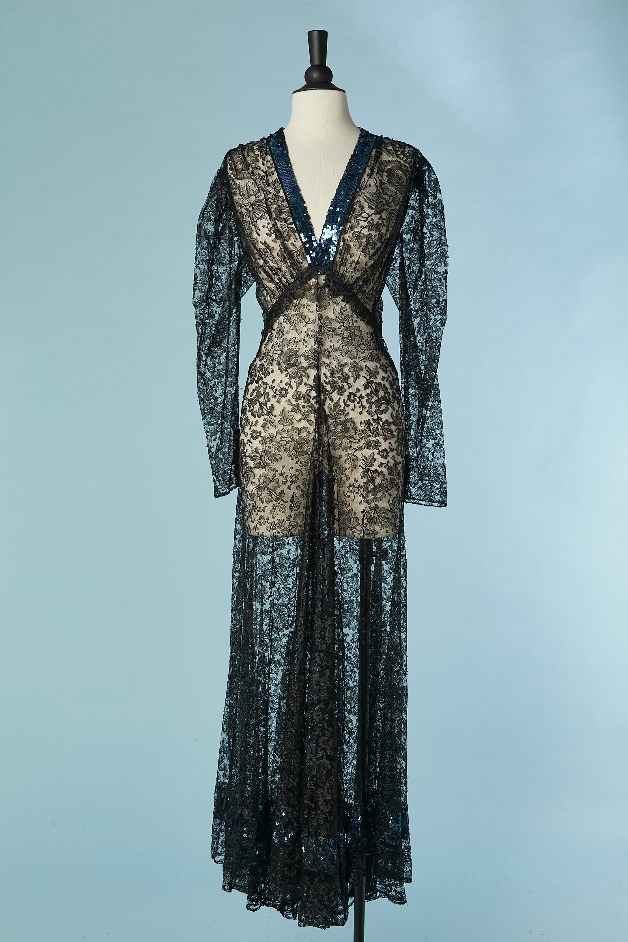 See-through black lace evening dress with blue sequin embellishement. Small buttons covered with black silk and buttonhole on the cuffs. Cut-work. 
Total lenght in the front= 140 cm 
Total lenght in the back = 155 cm 
SIZE L 
