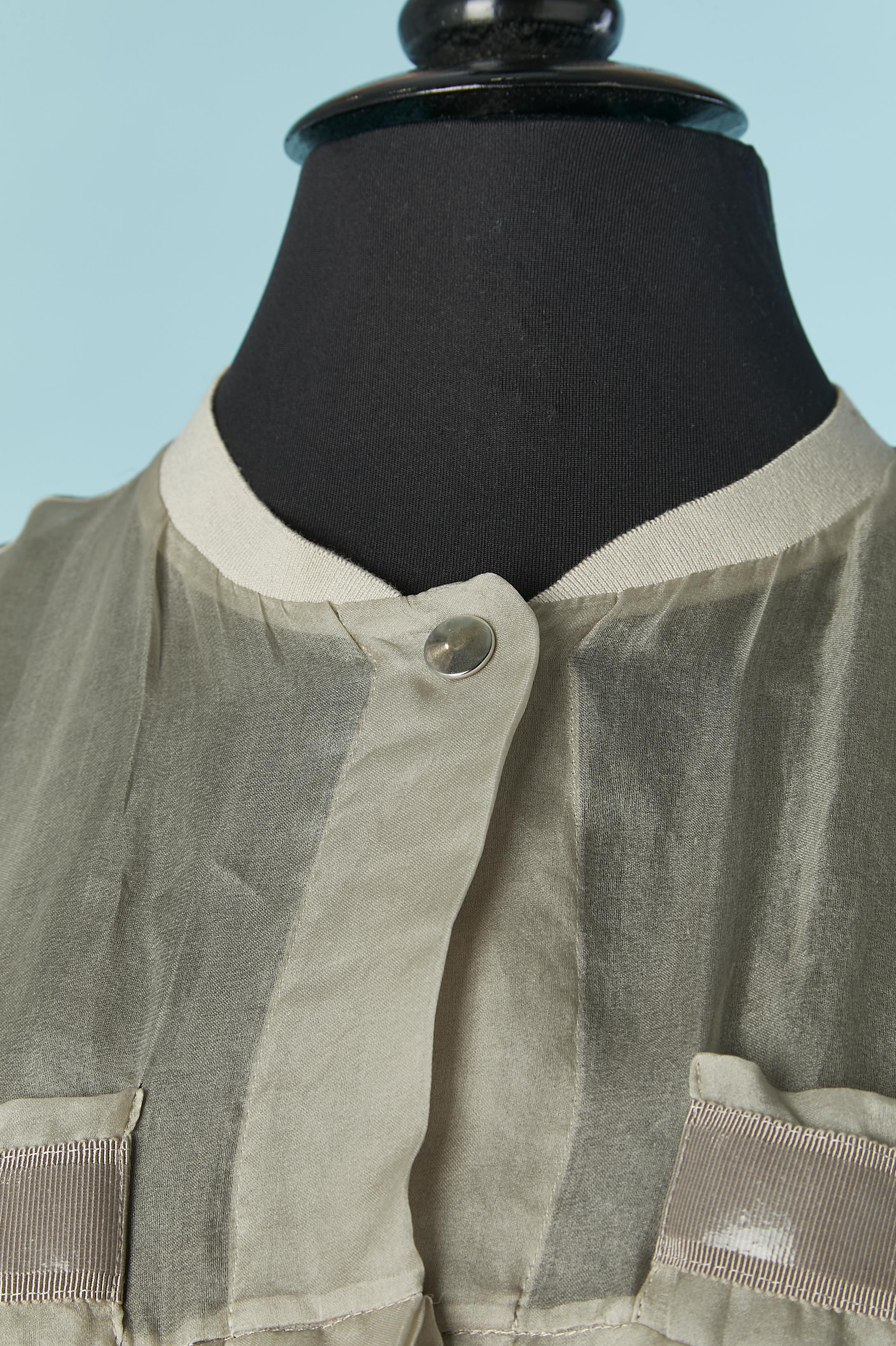 See-through silk pleated asymmetrical vest . Snap closure on the middle front and on the breast pockets . Rib details composition: 80% cotton, 17% nylon, 3% stretch. 
Drawstring on the bottom edge. 
Total front lenght= 50cm
Total back lenght =