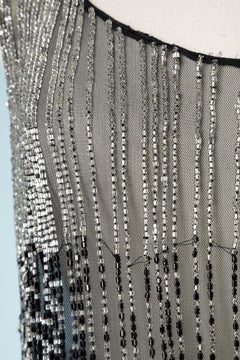 See-through tulle top with beads and feather embellishment