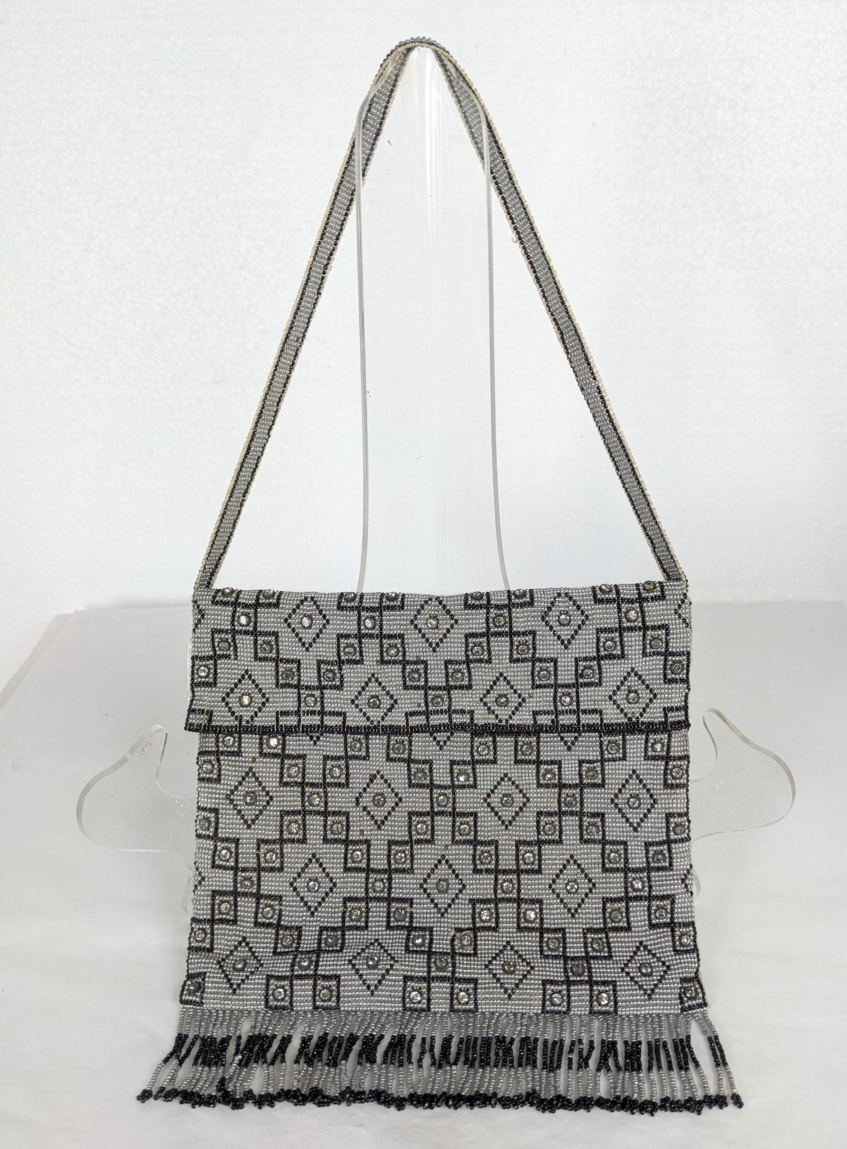 Charming Seed Bead Art Deco Bag with Crystals from the 1920's. Hand beaded with Art Deco patterns of seed beads with collet set crystals. Hard frame on top, does not sag, however will not hold a smart phone. Fraying on silk under flap. Handle 14
