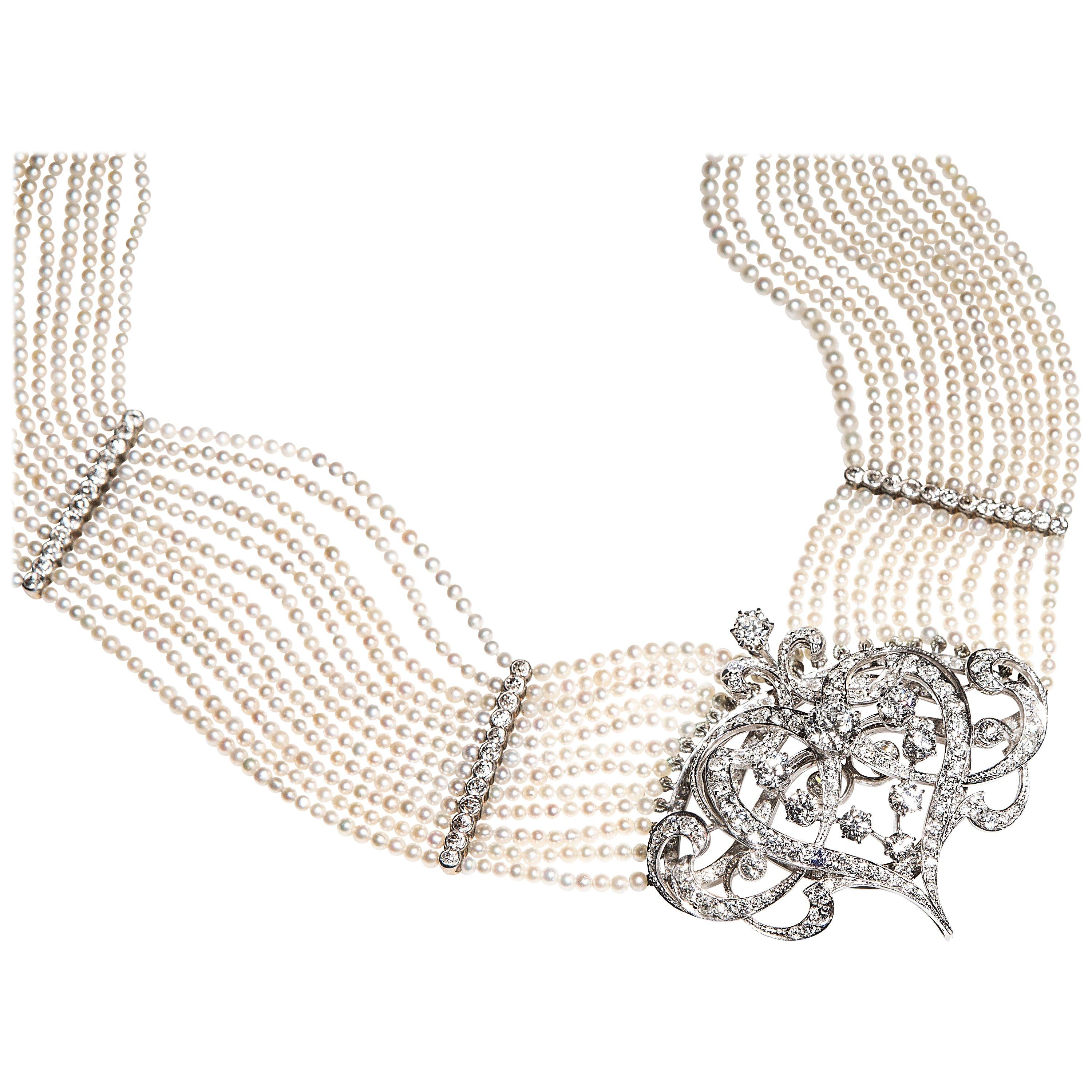 Stunning choker composed of 12 strands seed pearls (circa 2,5 mm to 3 mm) well matched, of cream body color with faint rose overtones. They are of good quality and luster. The strands are divided by finely wrought partitions made of platinum and