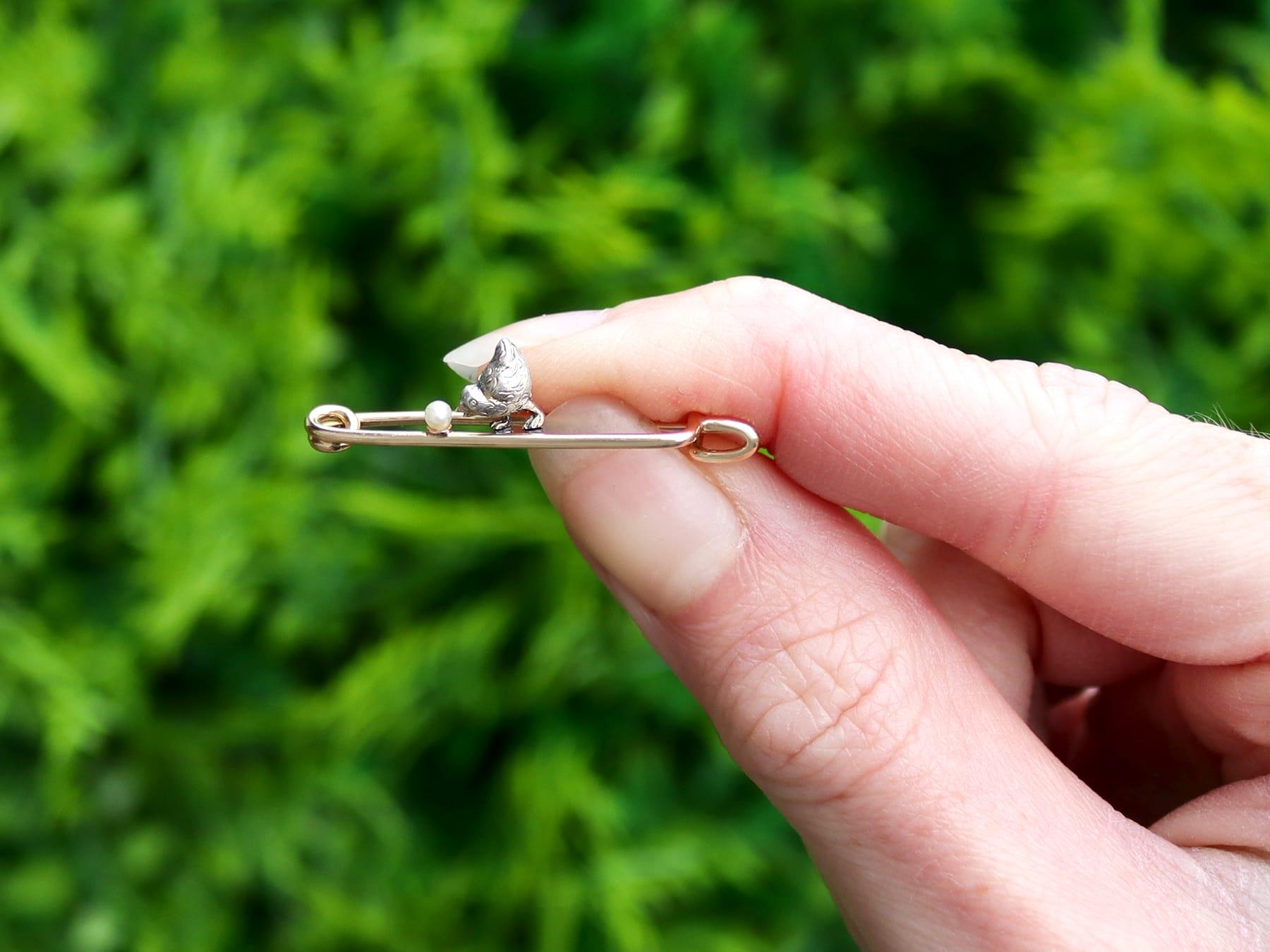 A fine and impressive antique seed pearl, 14k yellow gold and silver chick brooch; part of our diverse antique jewelry and estate jewelry collections.

This fine and impressive antique brooch has been crafted in 14k yellow gold and silver.

The