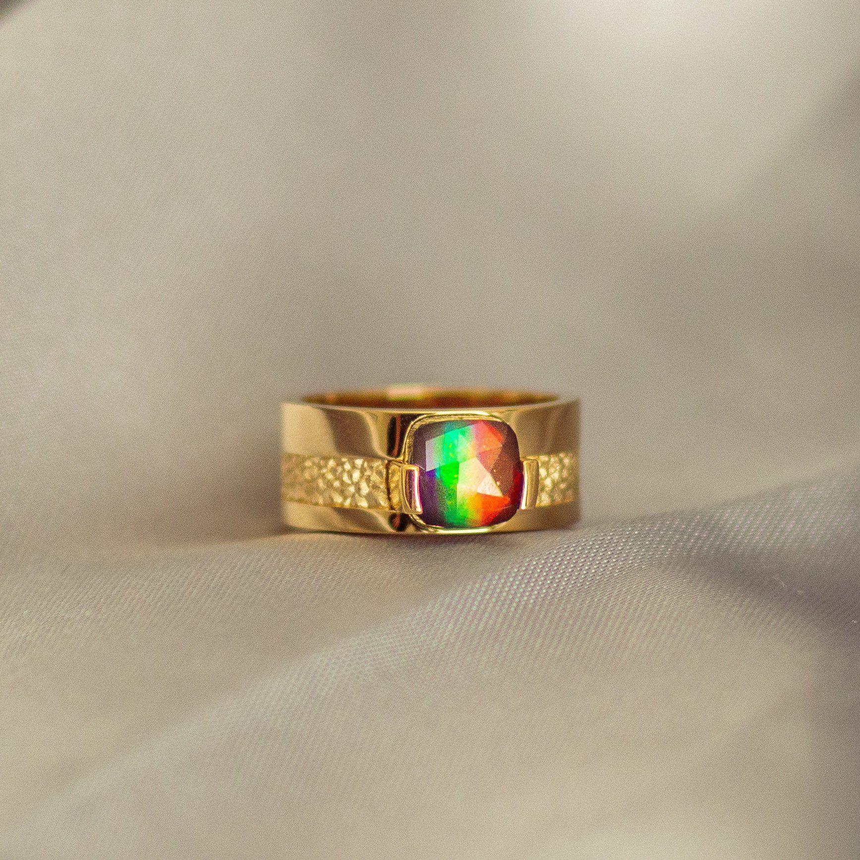 Martha Seely designed, AA grade 8mm x 8mm cushion Ammolite set in 14K Yellow gold.

Since 1979, KORITE has been the home of superior Ammolite, inspiring the world with the rarity and beauty of Canada’s gemstone. KORITE Ammolite is as unique as you