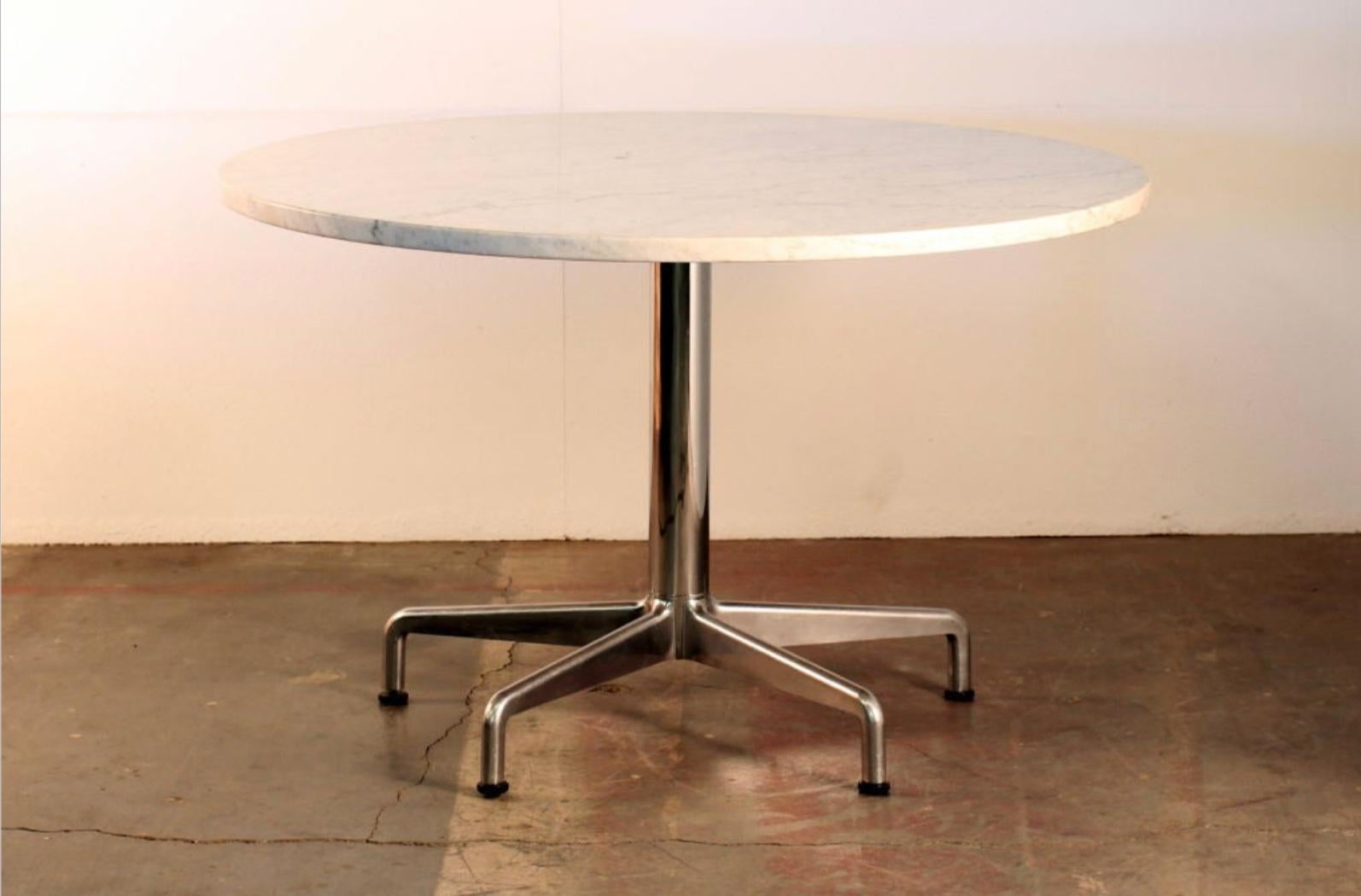 Thick marble-top round 70s dining table.