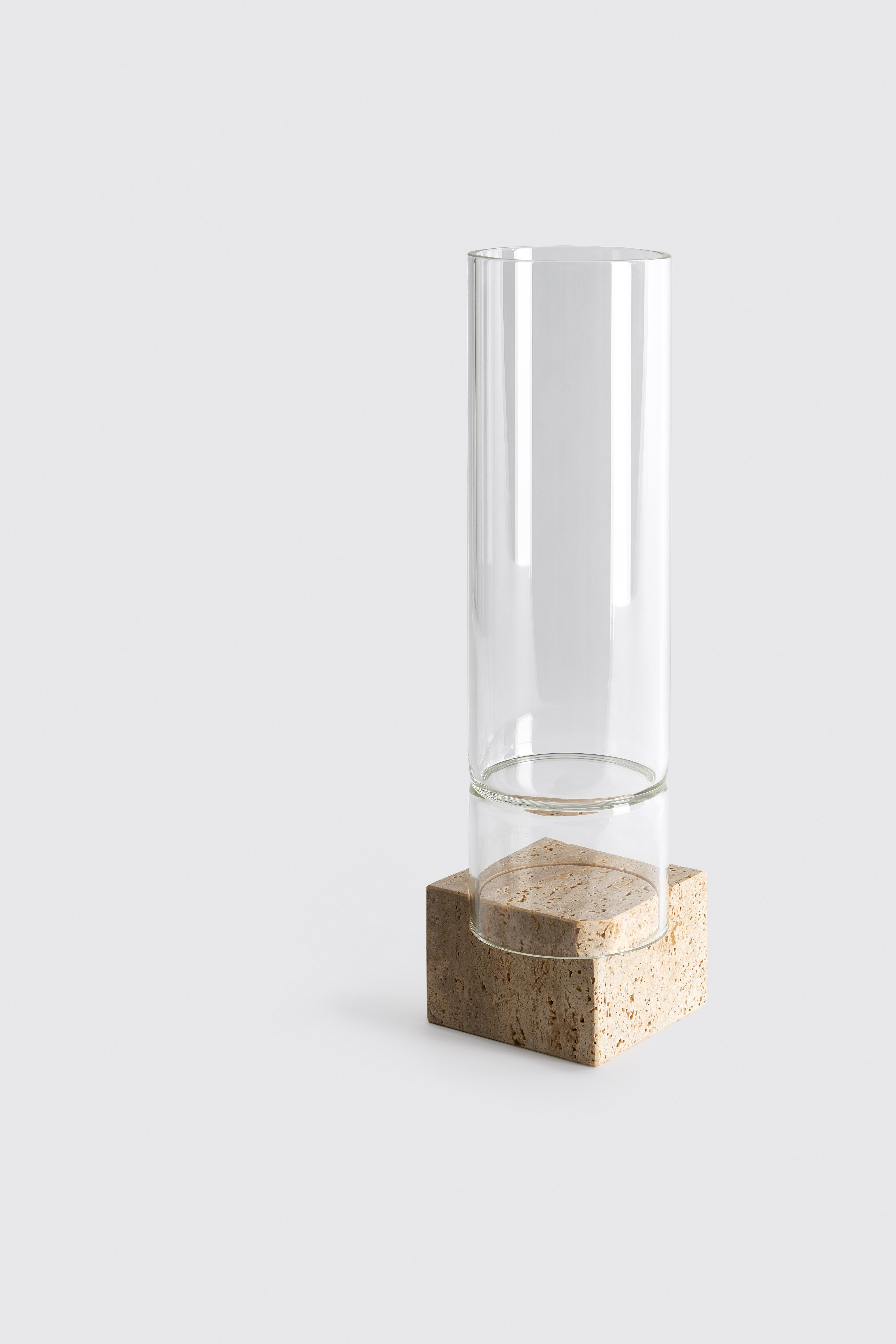 Segno vase I - Giorgio Bonaguro
Dimensions: D 12 x W 12 x H 44 cm
Materials: Travertine, glass.

A collection that was born from the desire to recover marble processing waste: small portions of slabs with different thickness, otherwise unused,