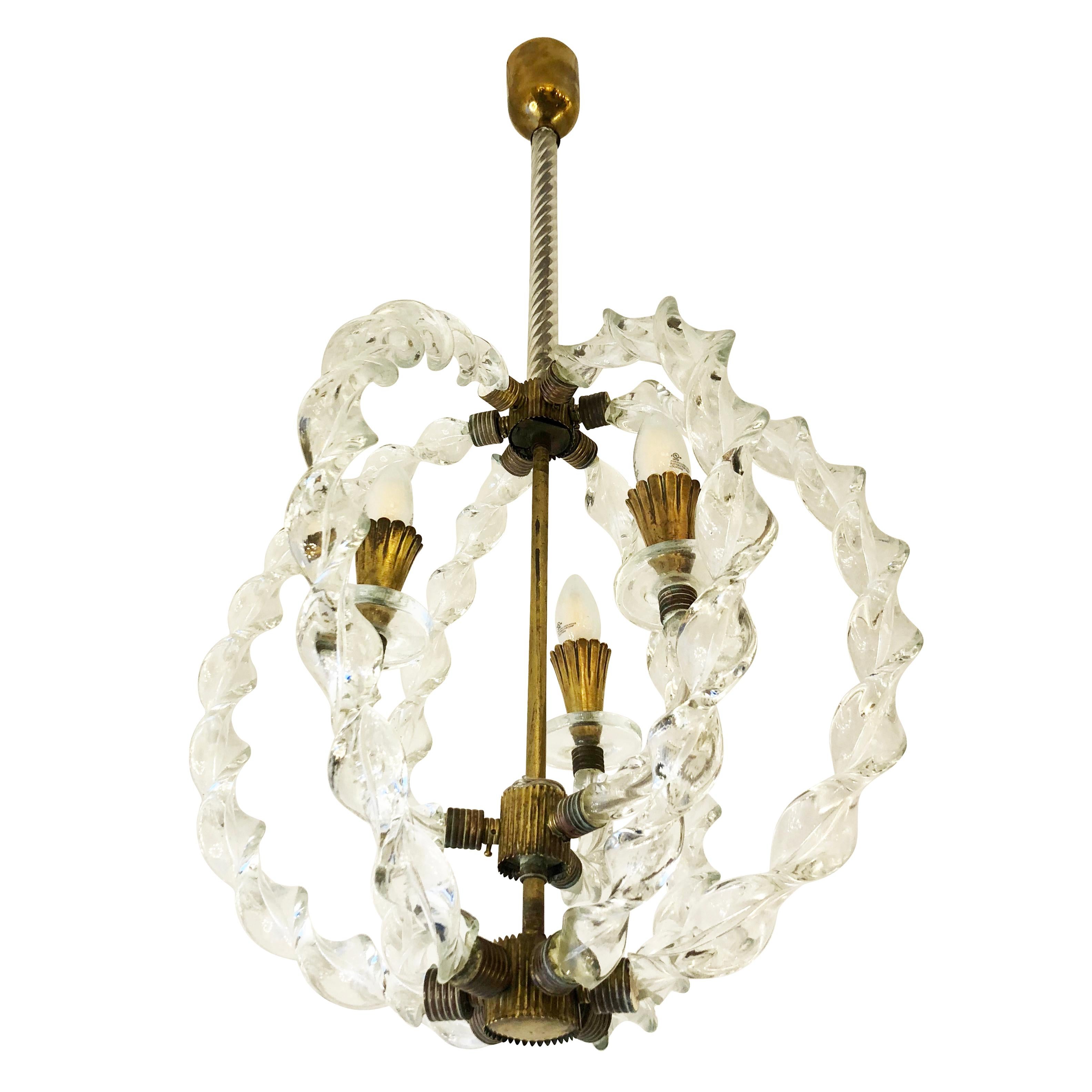 1940s pendant attributed to Seguso. Six Murano glass braids encircle three arms ending with the light sources. Brass fittings. Holds three E12 sockets.

Condition: Excellent vintage condition, minor wear consistent with age and use

Measures: