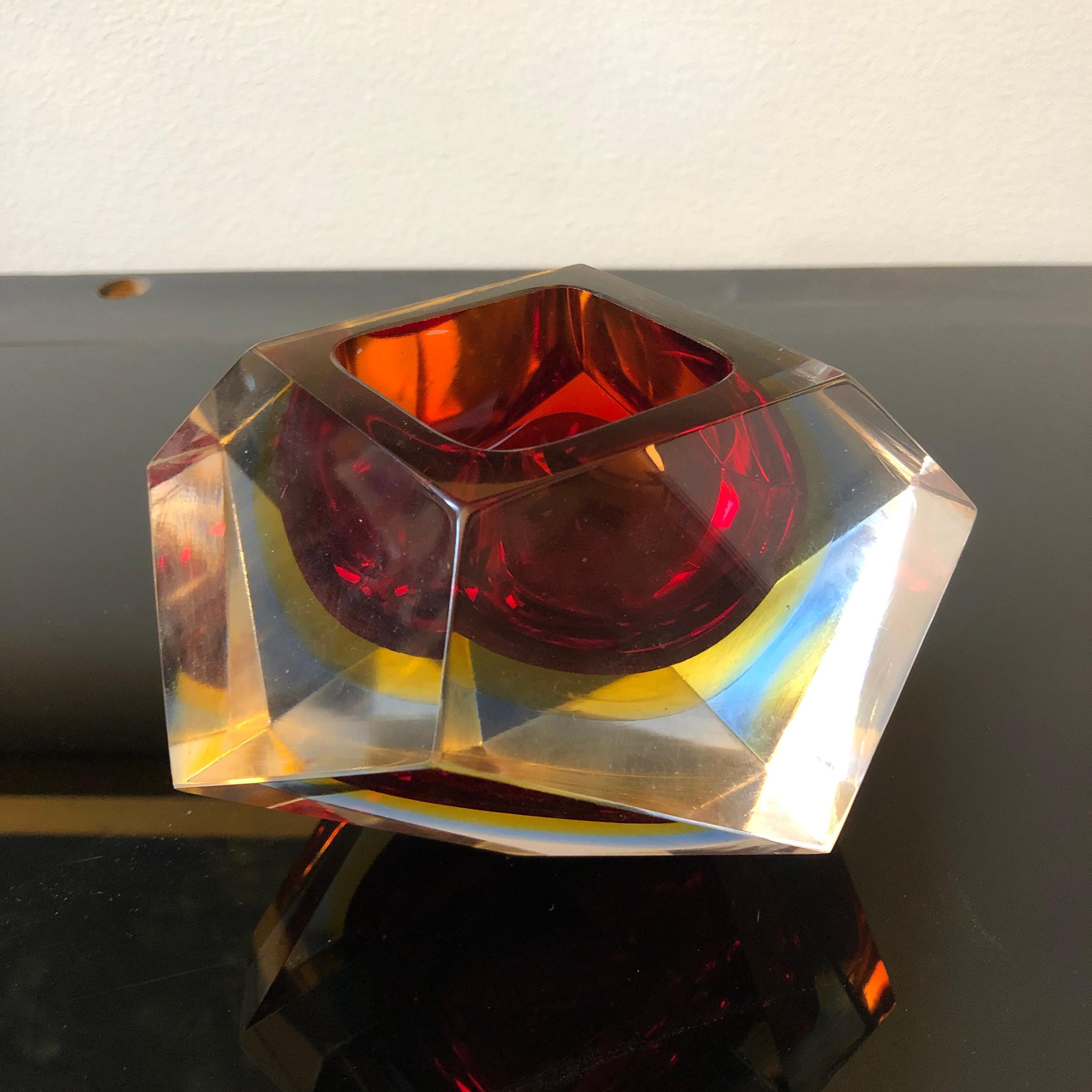 It's an iconic ashtray by Seguso, made in Italy in the 1970, red and yellow Murano glass.