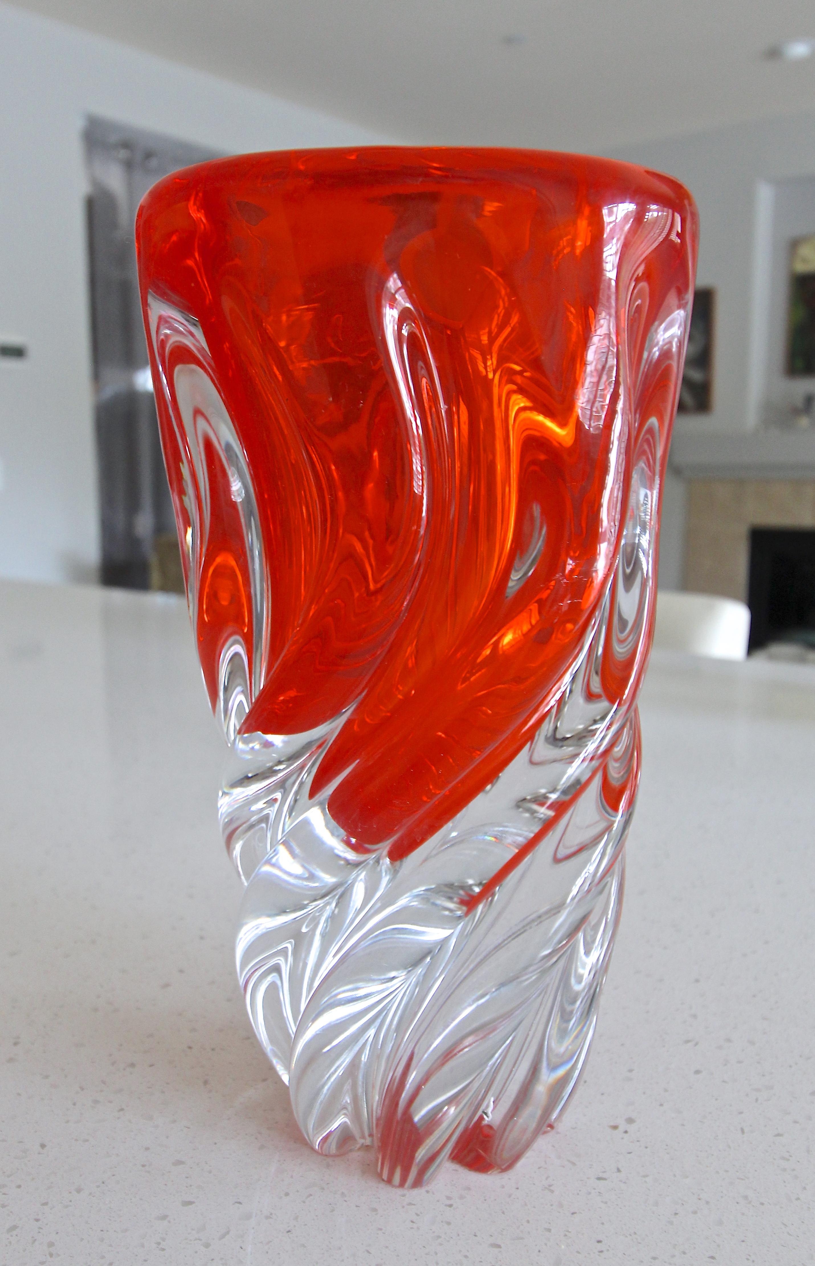 A truly luxurious Murano vase styled with thick twisted clear and blood orange colored hand blown glass. Squared shaped at top tapering smaller at base. Vase is expertly crafted and is heavy weighing over 12 pounds. Has gold label 