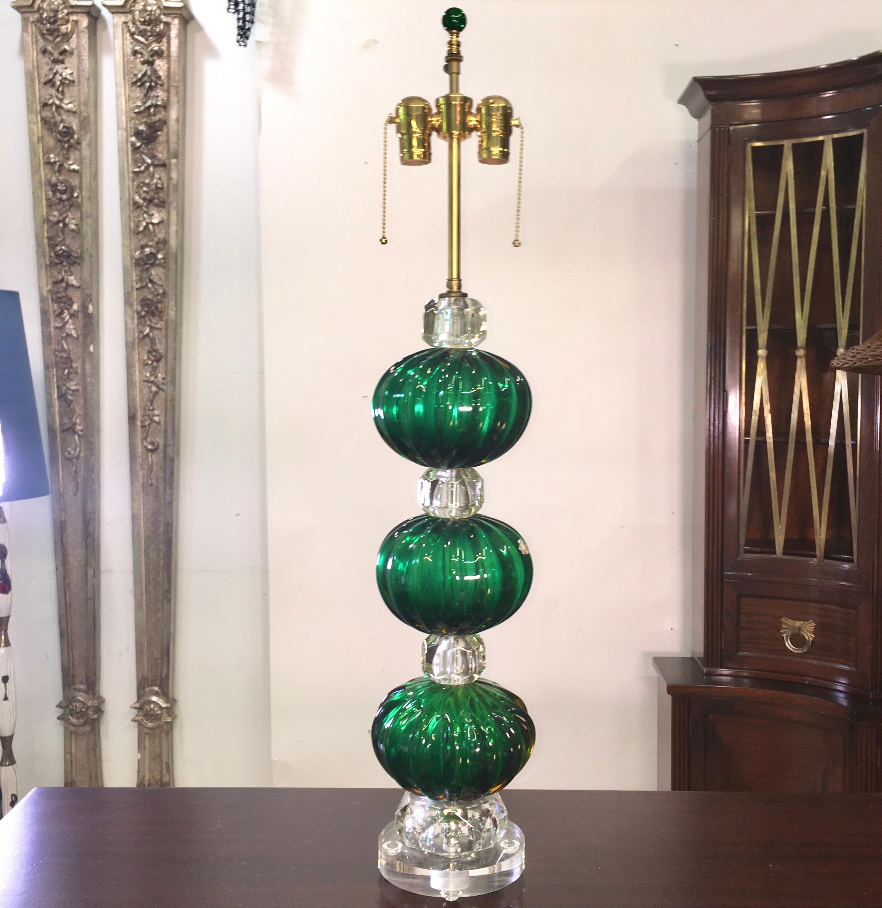 This knock-out lamp has been completely rebuilt and rewired using vintage Seguso Murano glass emerald green balls the size of cantaloupe, crystal spacers, lucite base and high quality solid brass lamp fittings. Height adjustable shade riser,
