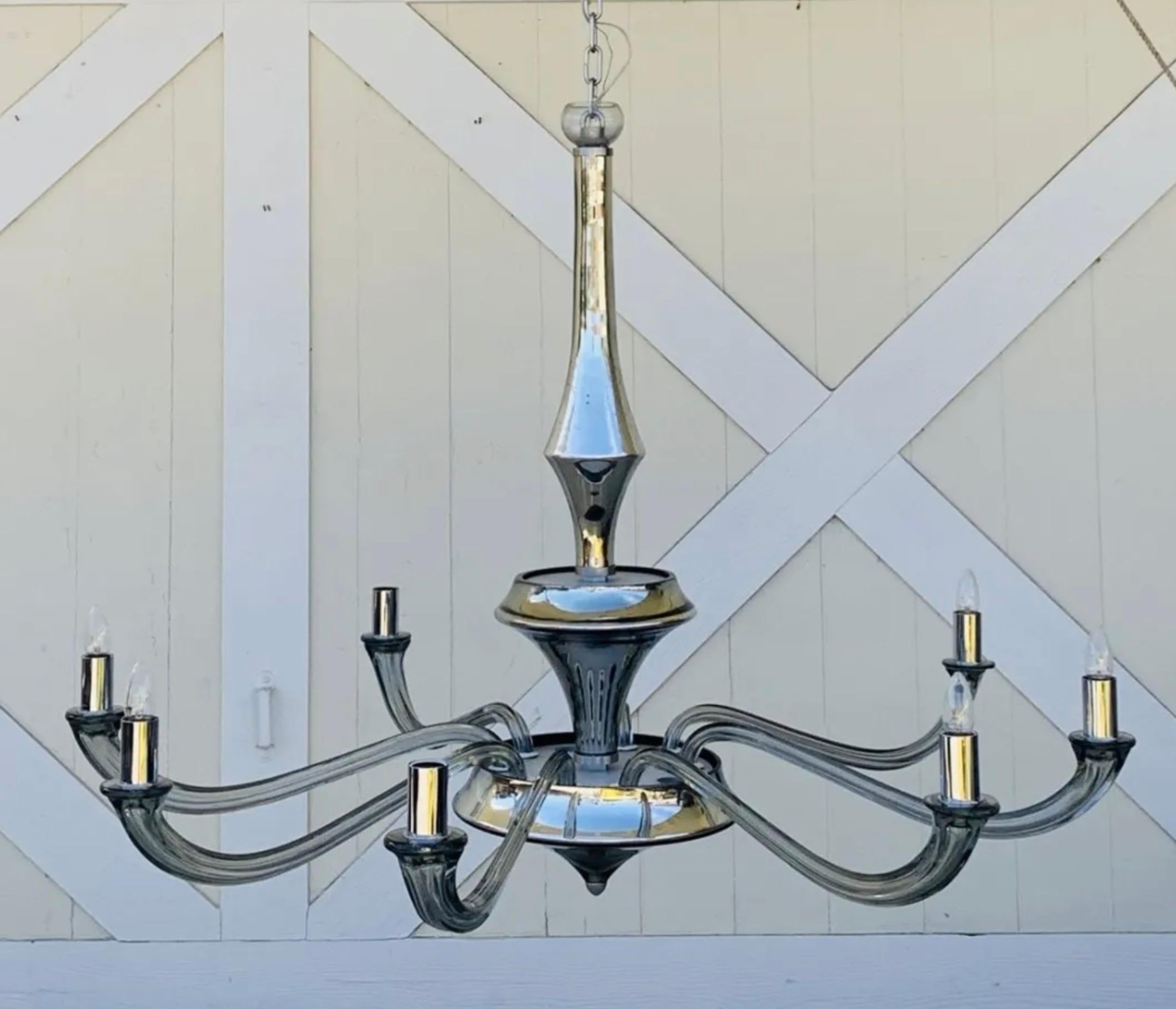 Beautiful chandelier created by Seguso for the Angelo Donghia showrooms. The piece center pieces in the main structure have a mercury silverish tone and the arms are a in a gray color. Each arm is 24 inches long and the complete diameter is 55